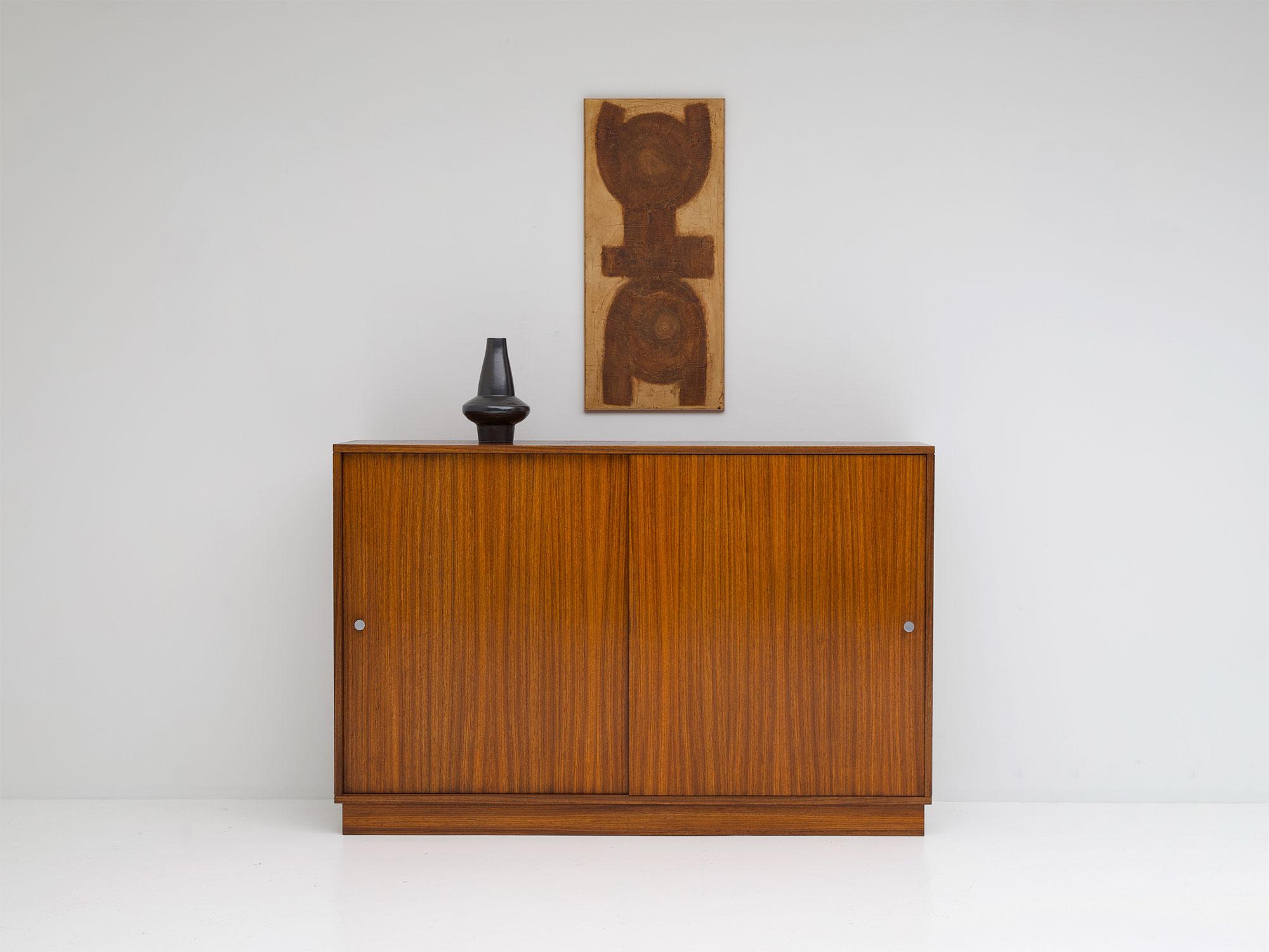 Alfred Hendrickx, Belgian modern, zingana wood, sliding doors, Belform Belgium 1960s

This cabinet was designed by Alfred Hendrickx for Belform in the mid-1960s. It has two sliding doors and offers a lot of storage space due the shelves inside.
