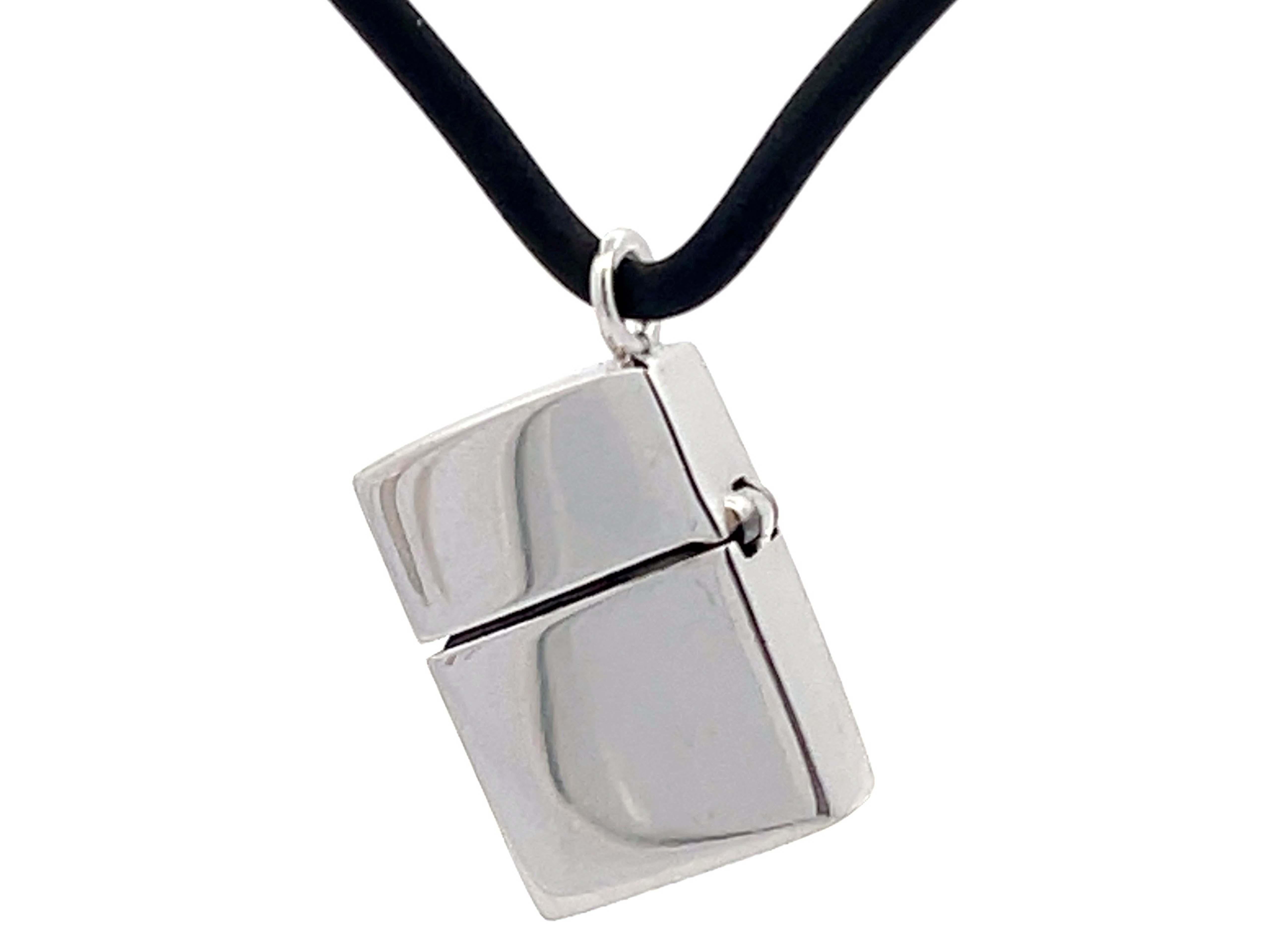 Zippo Lighter Pendant With Black Diamonds in 18k White Gold on Rubber Cord. There is ~0.12 carats of black diamonds. The pendant is approximately 16.5 mm x 12.2 mm and hangs on a 20