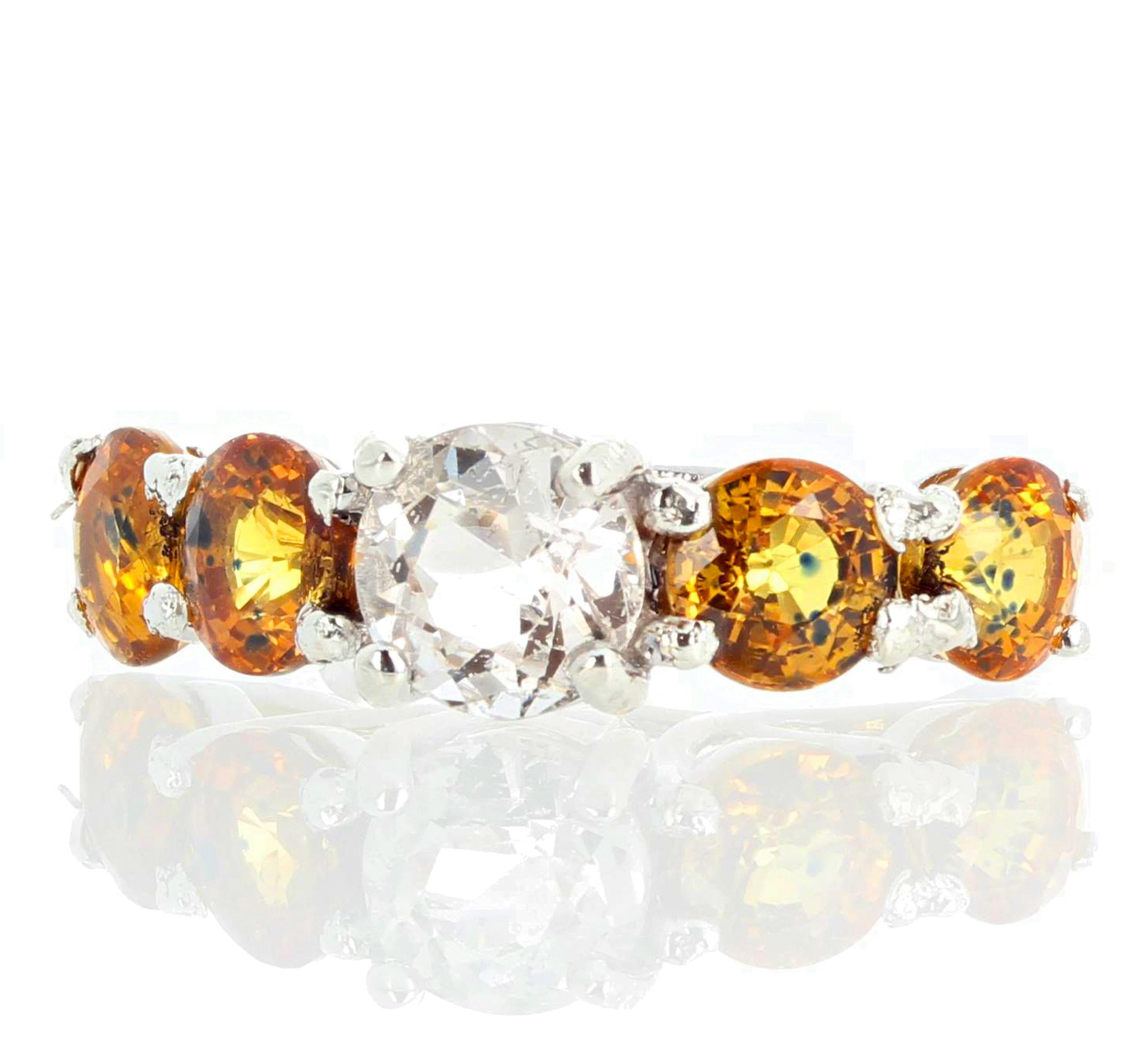 7.5 mm glittering natural white Cambodian Zircon is adorned with 4 5.8mm Songea fancy yellow color natural Sapphires set in a rhodium plated sterling silver ring size 7 (sizable).  More from this jeweler by putting Gemjunky into your 1stdibs search