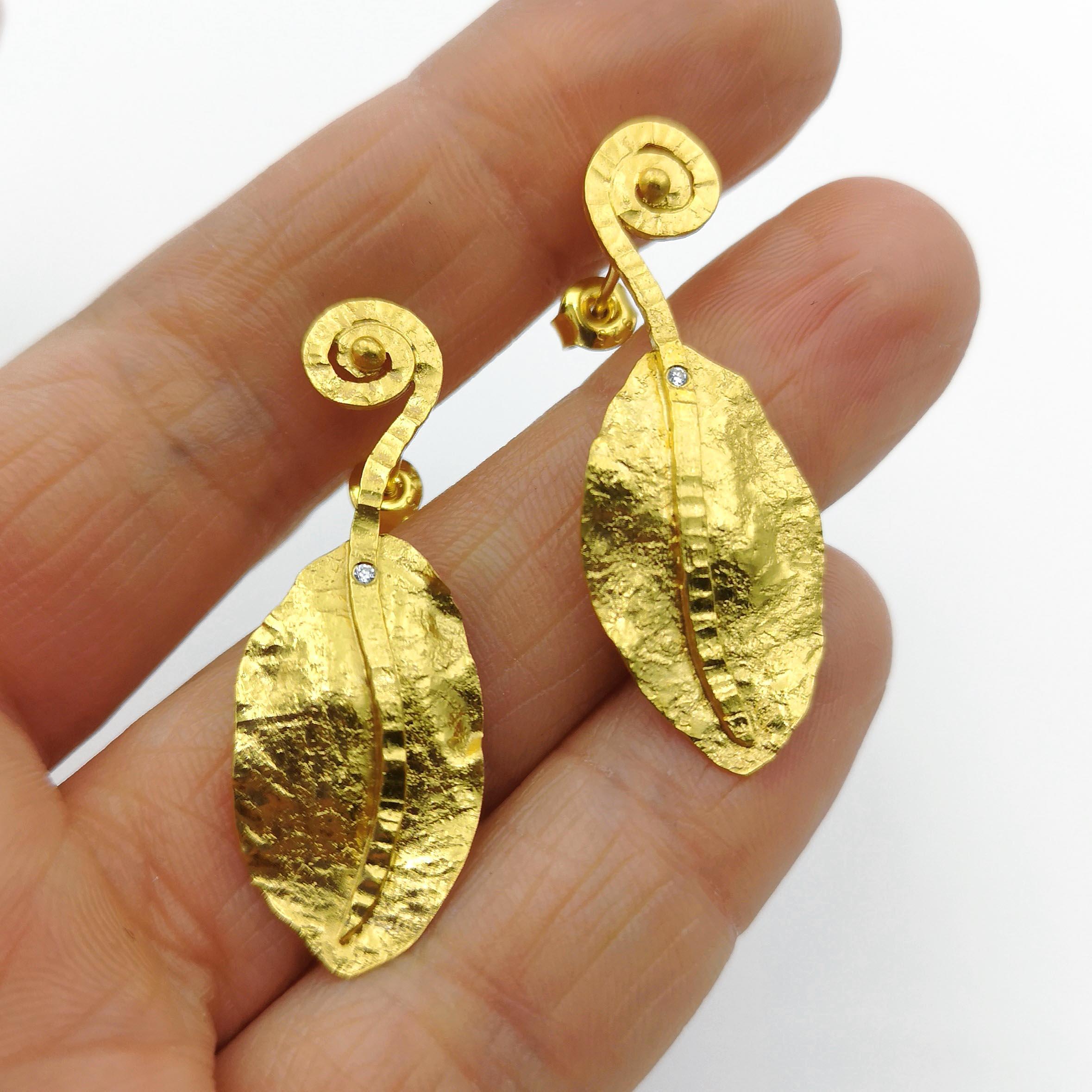 Zircon Gold Plate Silver Hand Made Artist Design Stud Earrings
Hand made earrings inspired by archeology, ancient cultures.
Hammered wavy leaves decorated with cubic zirconia (1.2mm) made of gilded silver. The uneven surface shows the play of light
