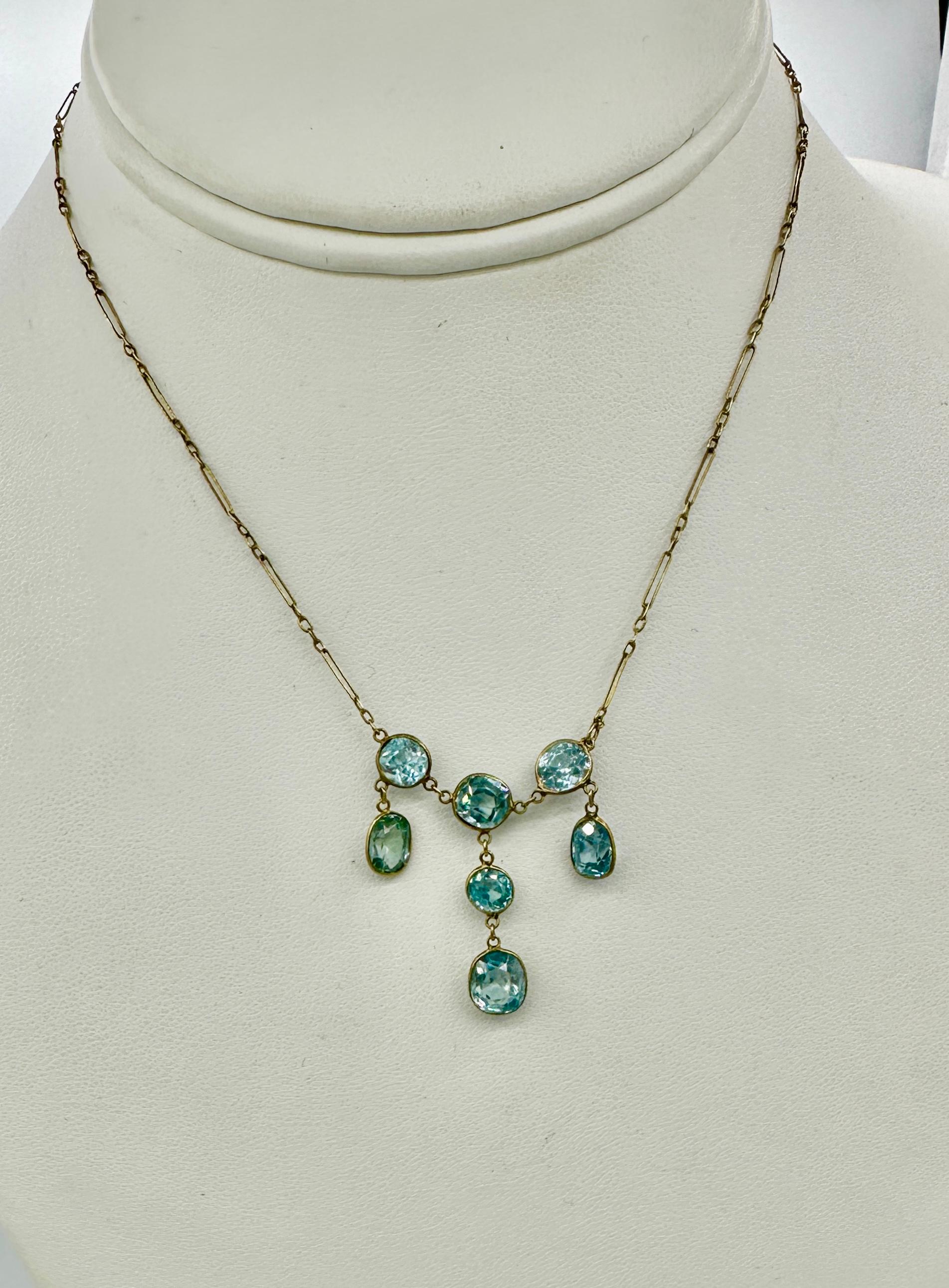 This is a stunning antique Retro Zircon Necklace with seven gorgeous round and oval faceted natural Zircon gems of great beauty in 10 Karat Gold. 
The antique Retro drop pendant necklace is absolutely wonderful and it is so rare to find necklaces