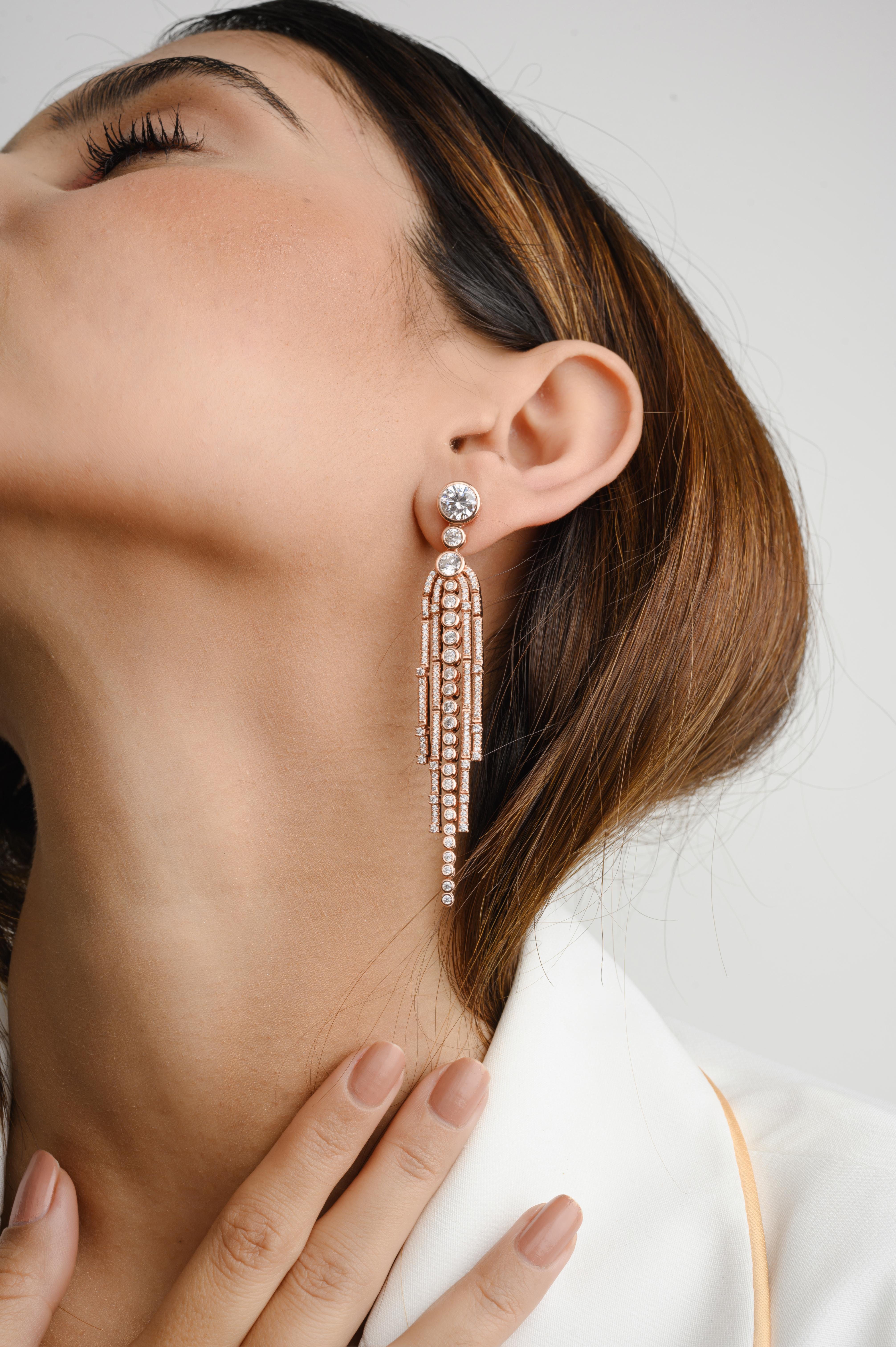 Rose Gold Plated Shoulder Length Dangle Earrings in sterling silver. You shall need dangle earrings to make a statement with your look. Each piece features dazzling cubic zirconia stones, renowned for their brilliance and clarity, set in