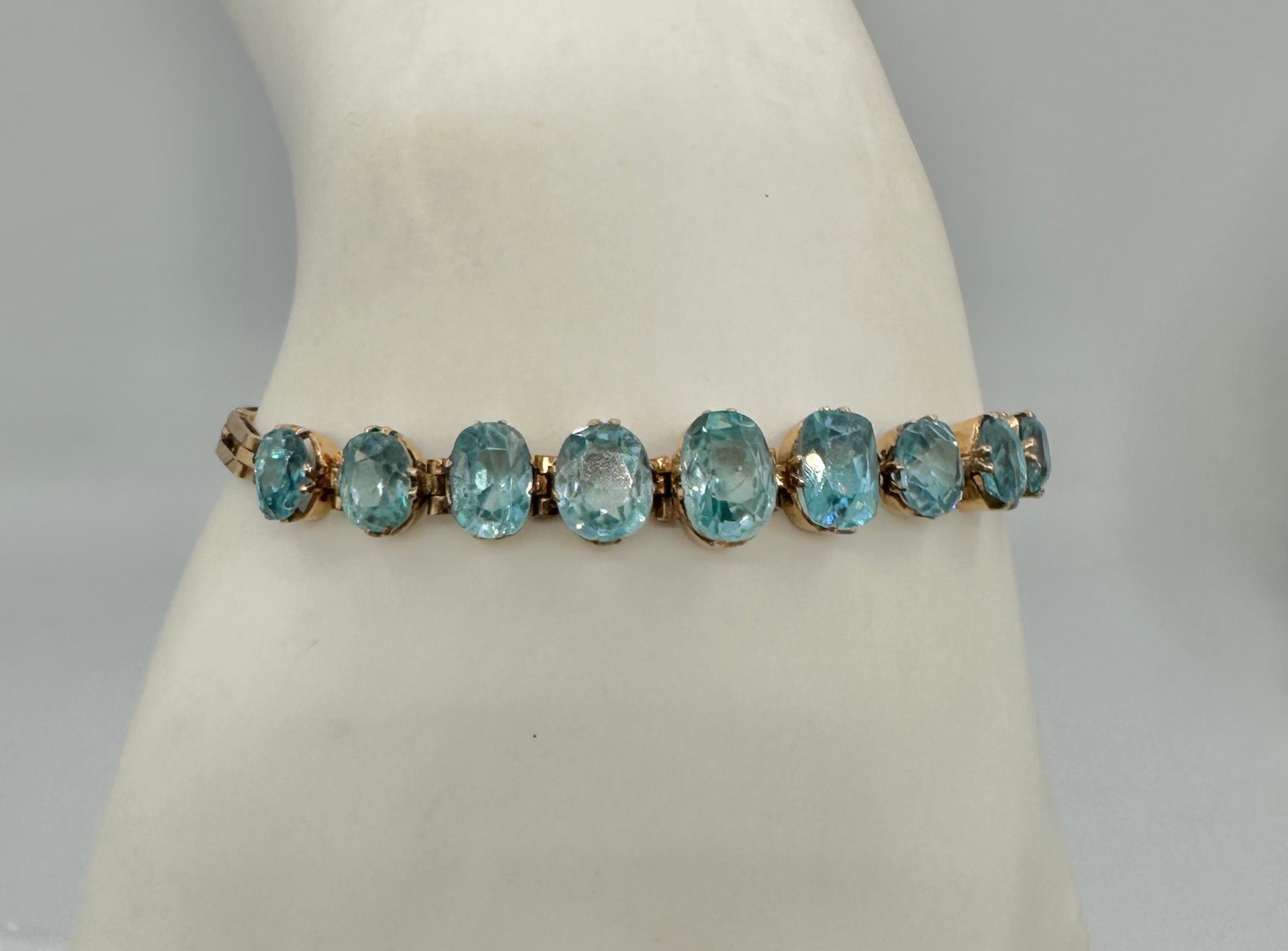 This is a stunning Retro Zircon Bracelet with nine gorgeous oval faceted graduated natural Zircon gems of great beauty in 10 Karat Rose Gold. 
The antique Retro bracelet is absolutely wonderful and it is so rare to find tennis bracelets with