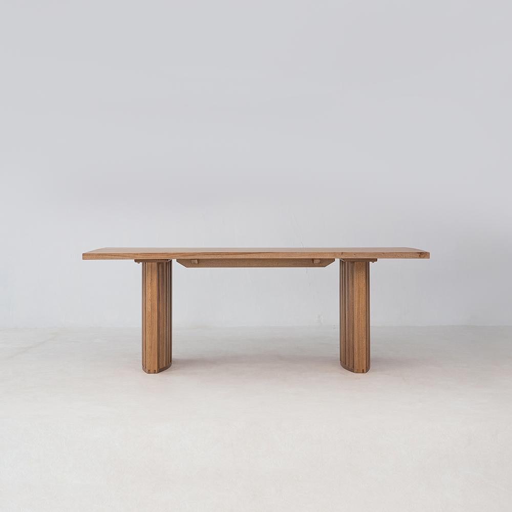 The Zither Dining Table features a vast solid hardwood plank top balanced by the intricate slatted base. Each tabletop is unique, showcasing the natural grain of the wood. Sealed with our proprietary, ecologically friendly finish, the table is easy