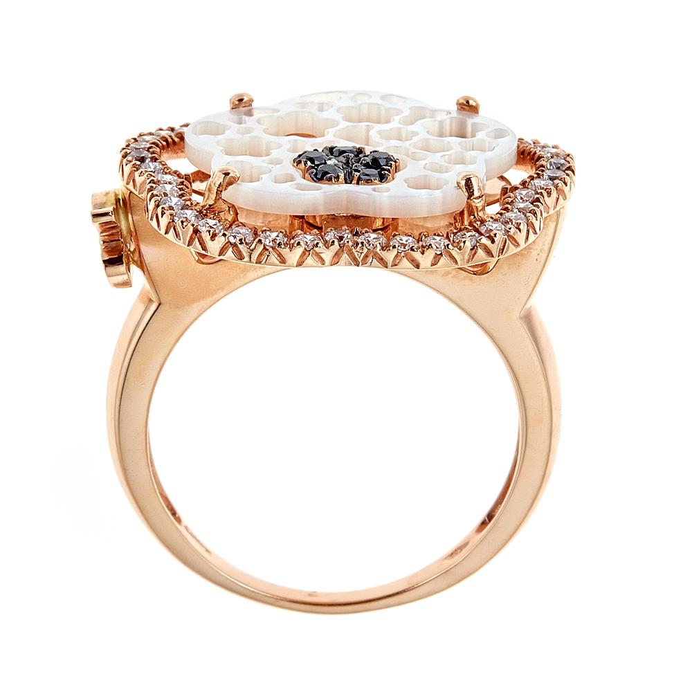 Zoccai Mother-of-Pearl Black and White Diamond 18 Karat Rose Gold Cocktail Ring

Intrigue design. Fashioned in gentle 18k Rose Gold, this glamorous ring showcases 3.2tcw mother of pearl set on top of the ring in a flower shape, embraced with a row