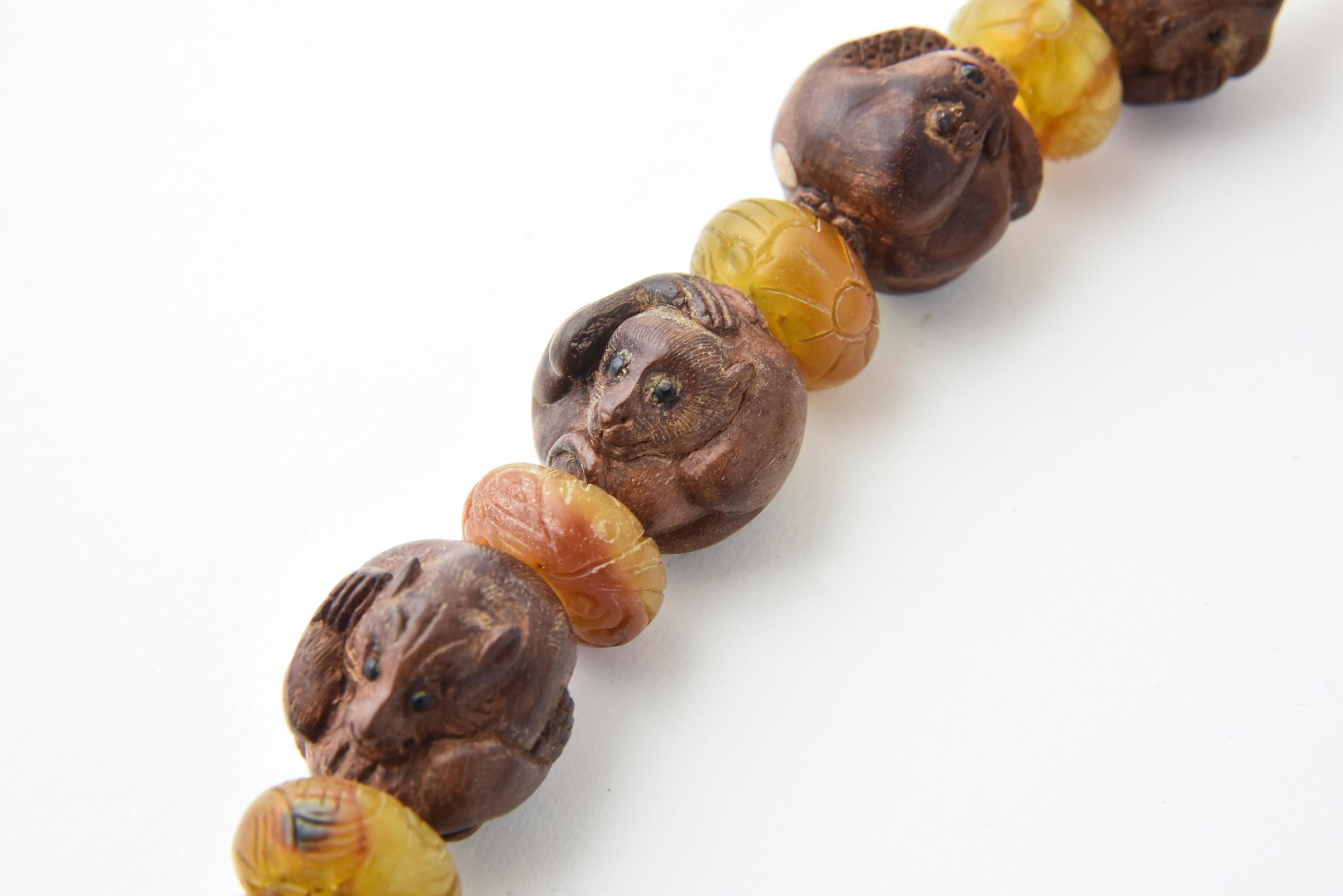 This beautiful Chinese Ojime necklace is made of carved nuts handcrafted into 12 Zodiac animal beads with onyx eyes.  The bead size ranges from 23 - 24mm.  The 12 zodiac animals include:  rat, ox, tiger, rabbit, dragon, snake, horse, goat, monkey,
