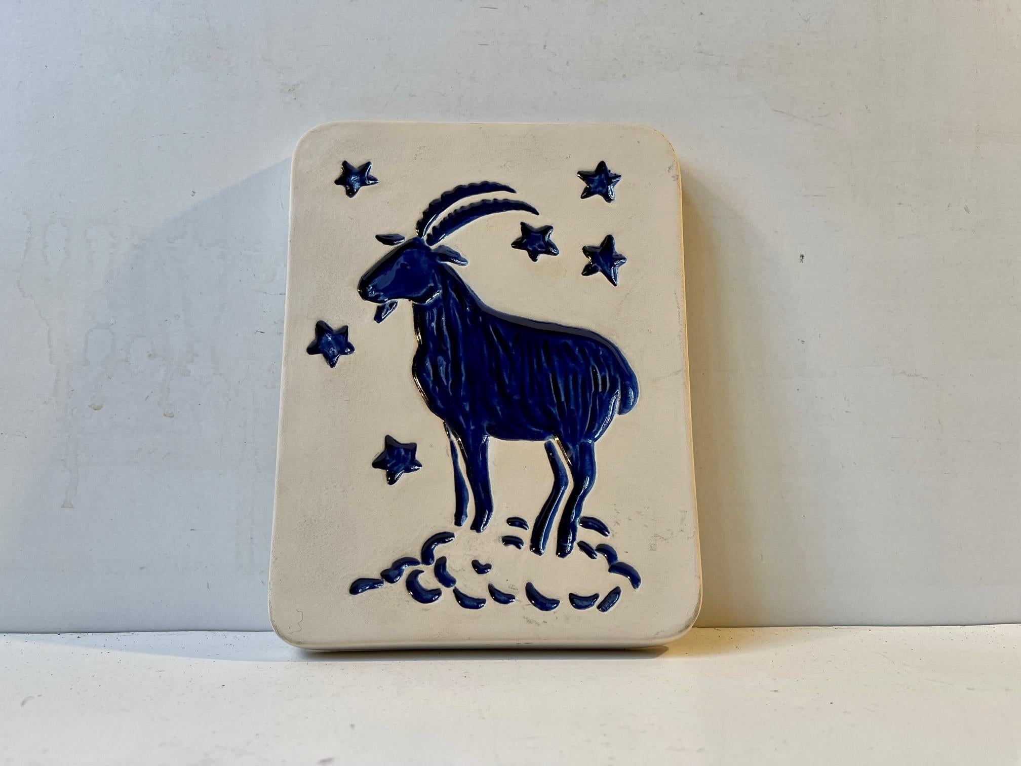 Ceramic wall plaque decorated with blue glaze. It depicts the Zodiac sign: The Capricon. Designed by Vallis and made at Gabriel Ceramic Studio in Sweden during the 1970s. Measurements: H: 16.5 cm, W: 13 cm, Dept: 2 cm.
