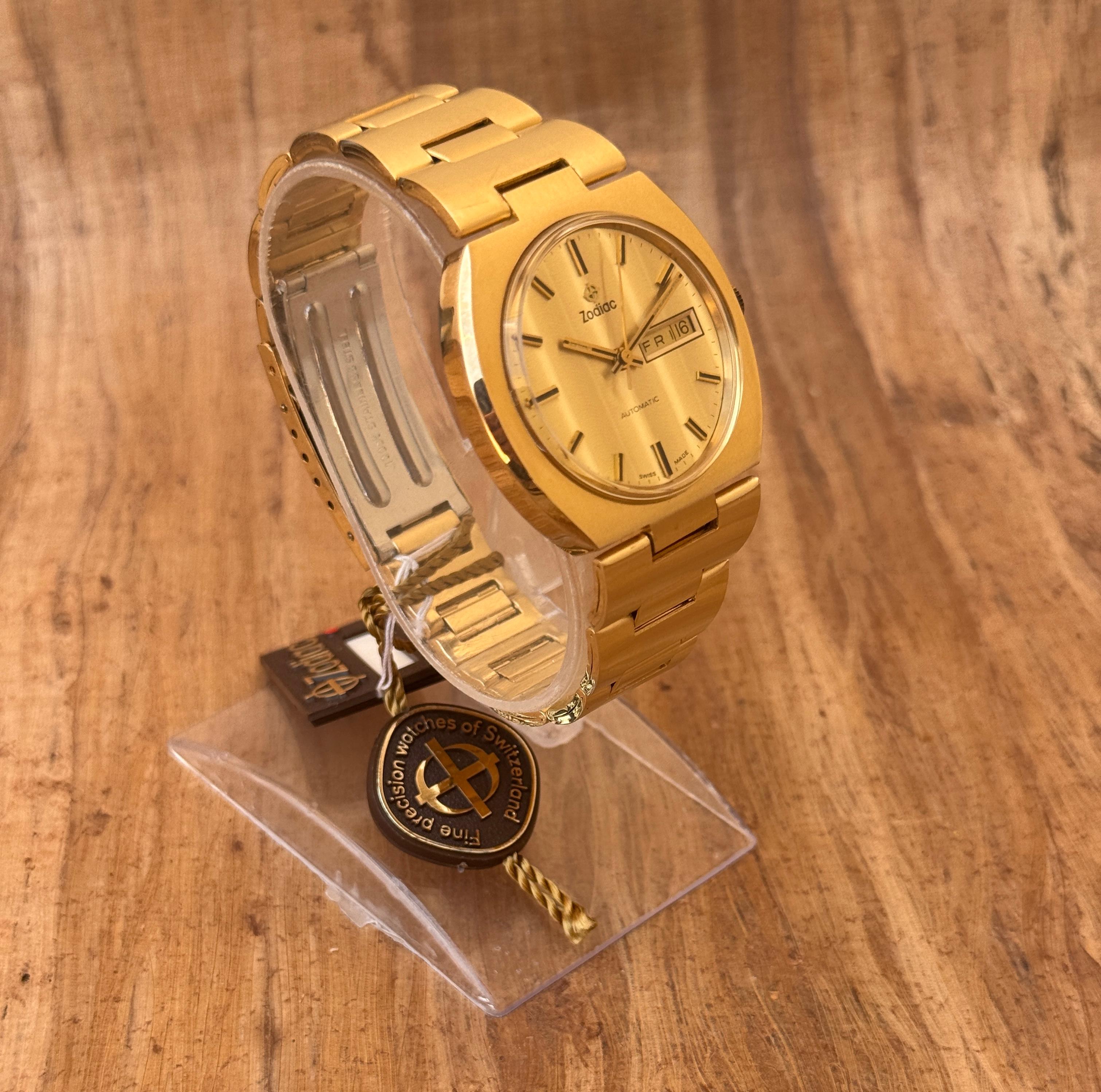 Brand: Zodiac

Model: OLYMPOS

Reference Number: 763.692

Country Of Manufacture: Switzerland

Movement: Automatic

Case Material: Gold Plated Stainless-steel

Measurements : Case width: 38mm. (without crown)

Band Type : Gold Plated