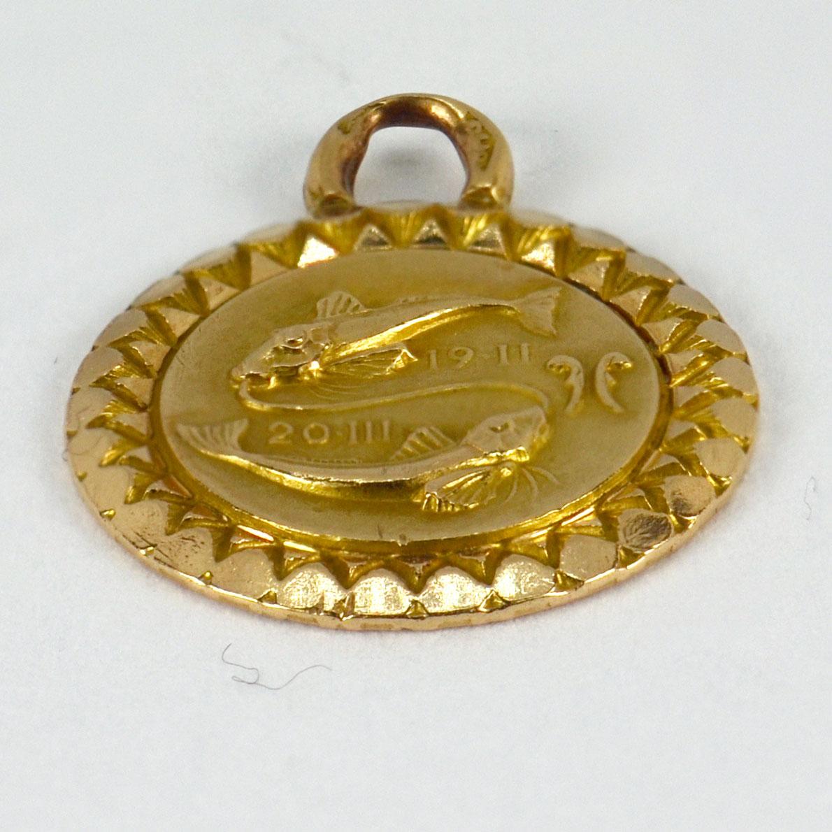 A French 18 karat (18K) yellow gold charm pendant depicting the double fish of the zodiac sign Pisces, with the dates 19-February - 20-March. Engraved to the reverse ‘Martine 19.3.51’. Stamped with the eagle’s head for French manufacture and 18