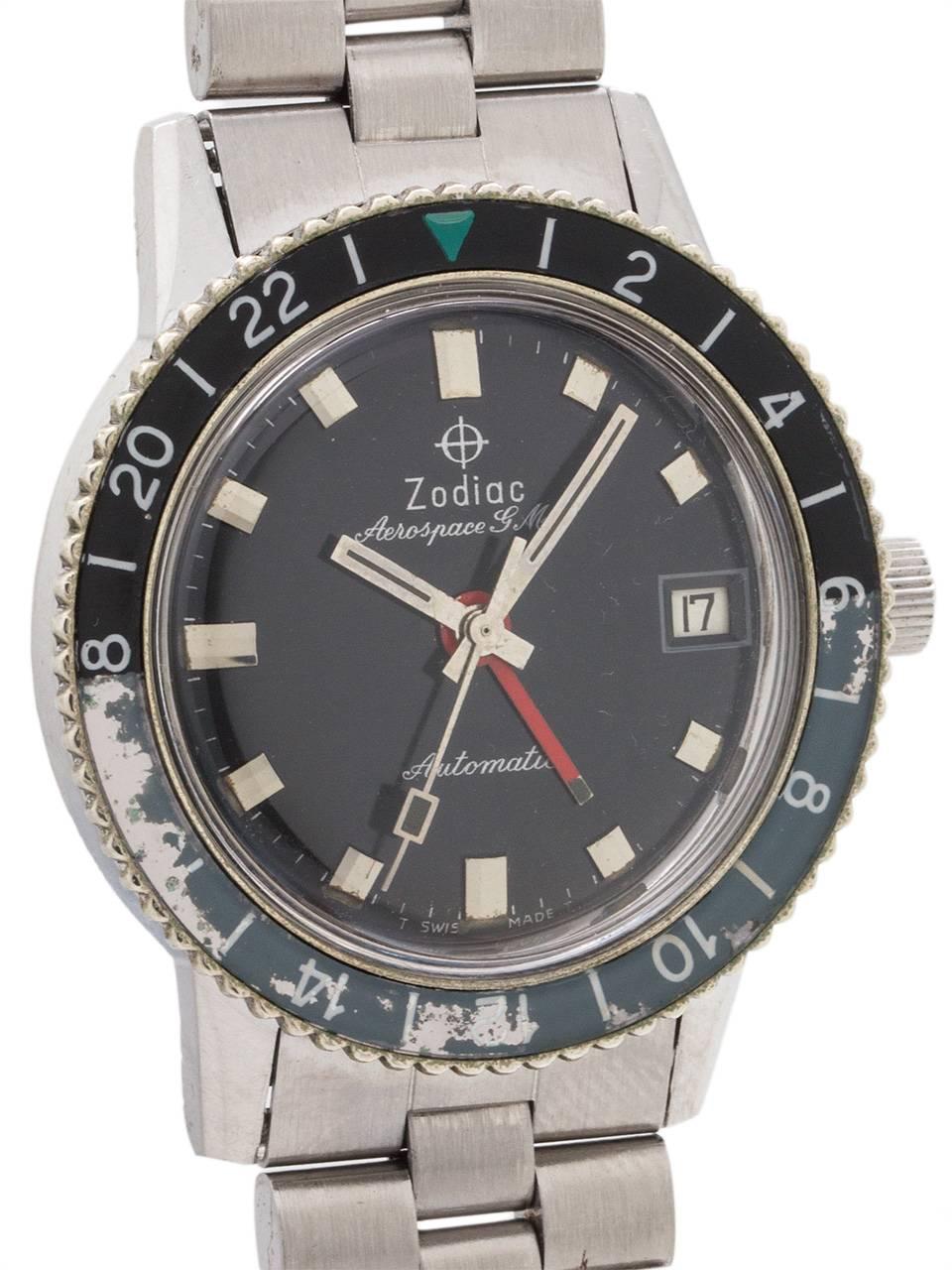 
Zodiac Stainless Steel Aerospace GMT automatic circa 1960’s. 36mm case with screw down case back, rotating 24 hour black and blue/gray acrylic bezel with green triangle 24 hour index, and a loss of color from 16-18. Glossy black original dial with