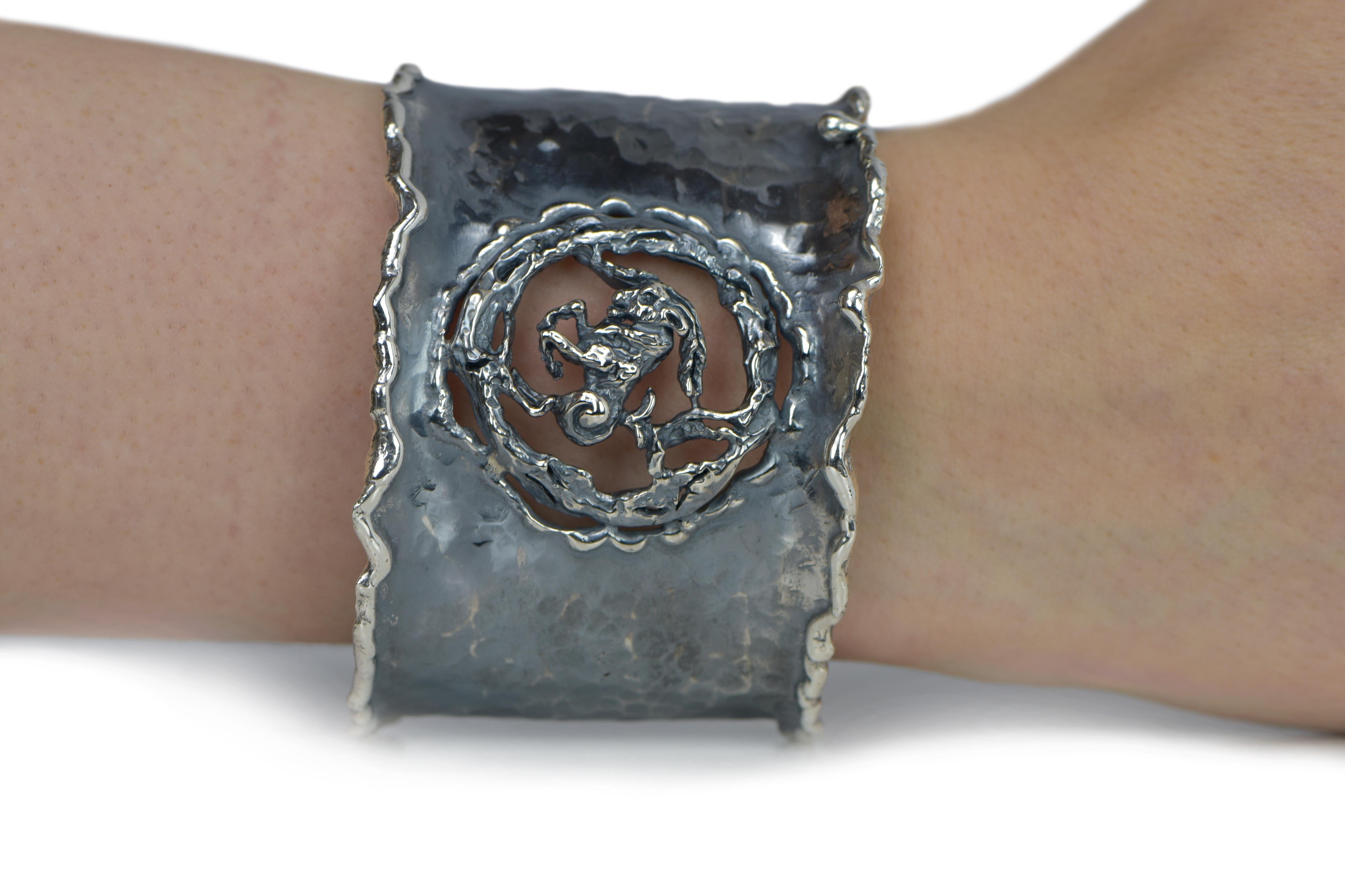 Hand Forged Silver Capricorn Adjustable Cuff Bracelet. About 2.5 inches wide. The metal does not contain any additional alloys that could compromise the strength or quality of the piece. Each Organic Silver Cuff Bracelet takes about 8 hours to