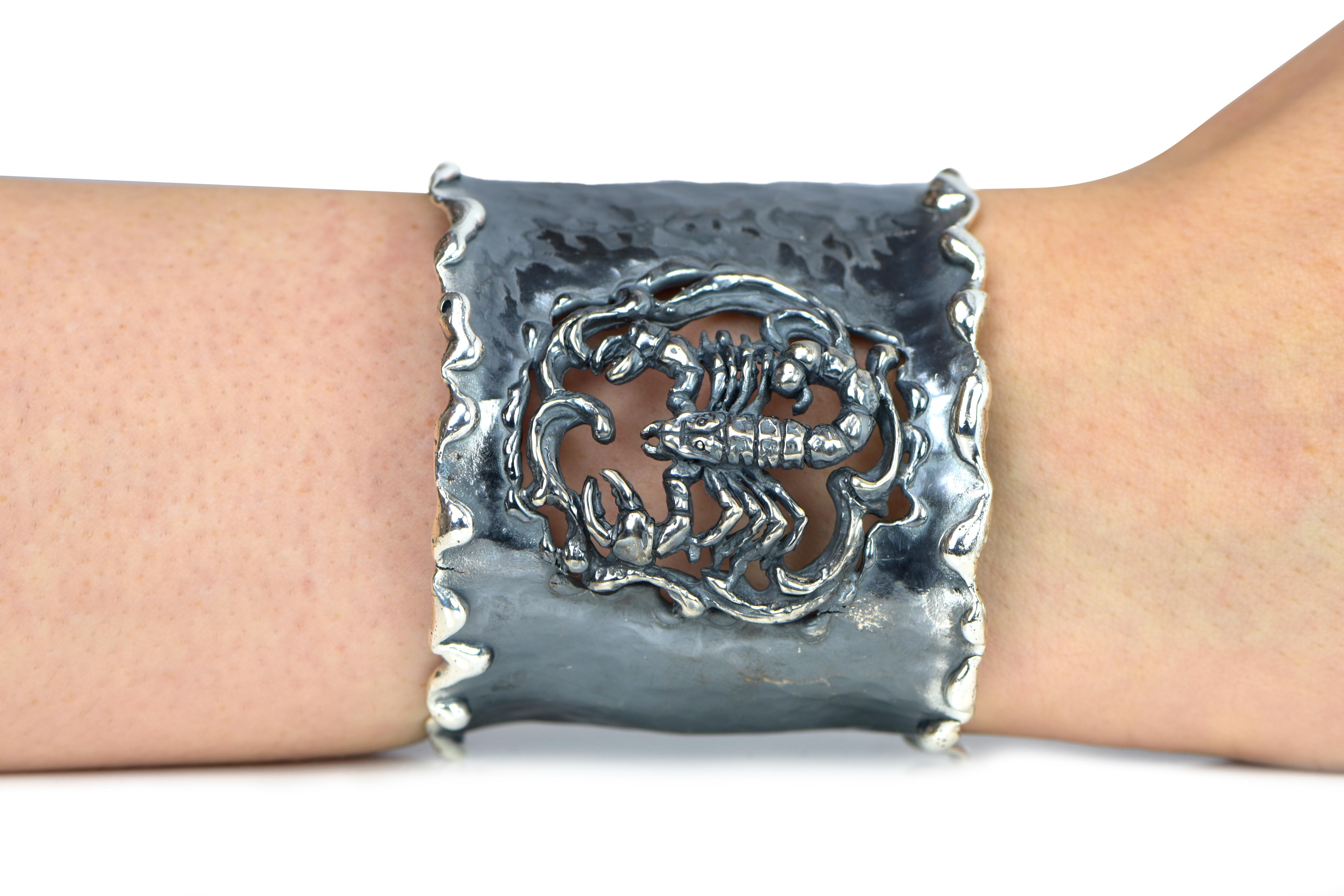 Hand Forged Silver Scorpio Adjustable Cuff Bracelet. About 2.5 inches wide. The metal does not contain any additional alloys that could compromise the strength or quality of the piece. Each Organic Silver Cuff Bracelet takes about 8 hours to