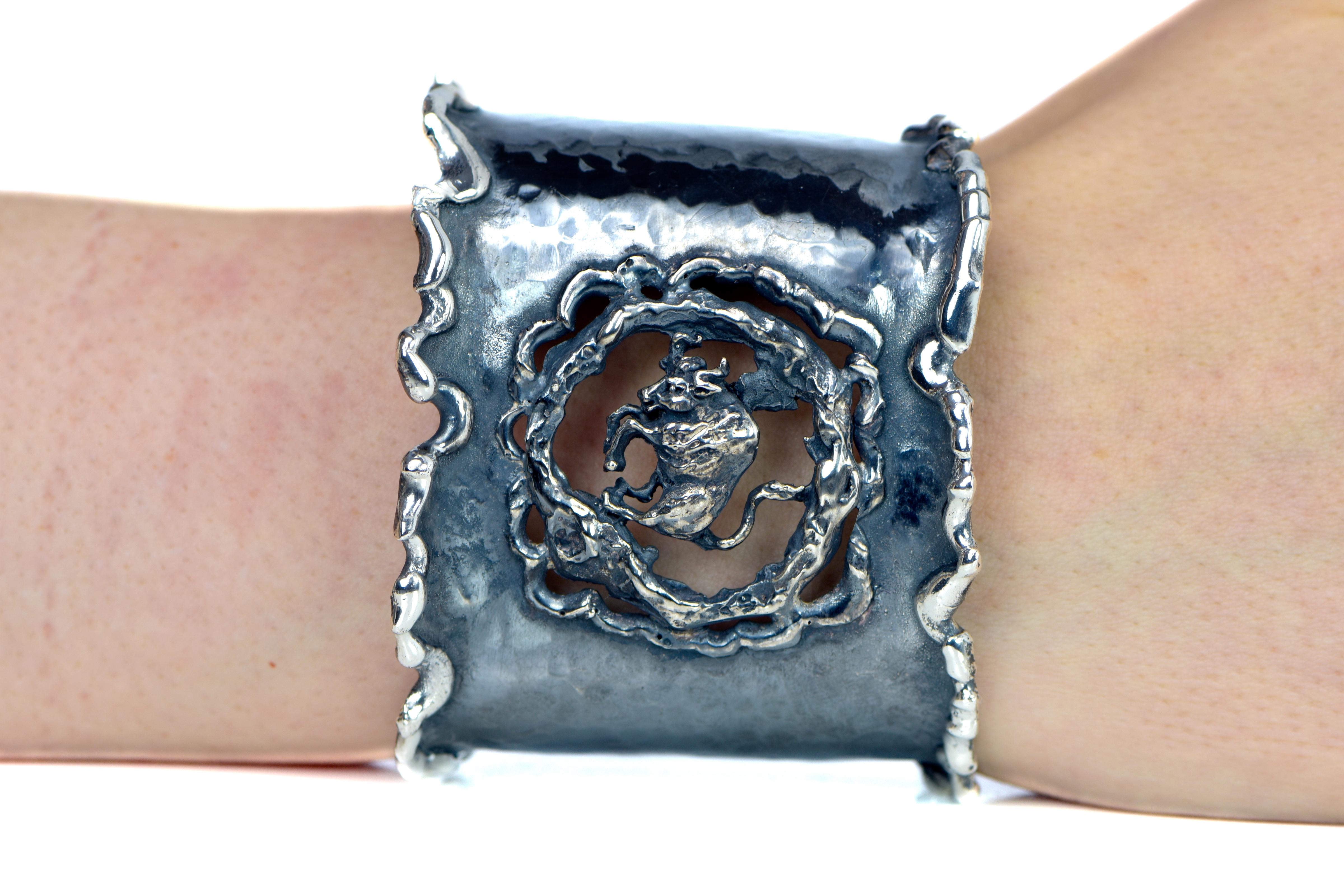  Hand Forged Silver Taurus Adjustable Cuff Bracelet. About 2.5 inches wide. The metal does not contain any additional alloys that could compromise the strength or quality of the piece. Each Organic Silver Cuff Bracelet takes about 8 hours to