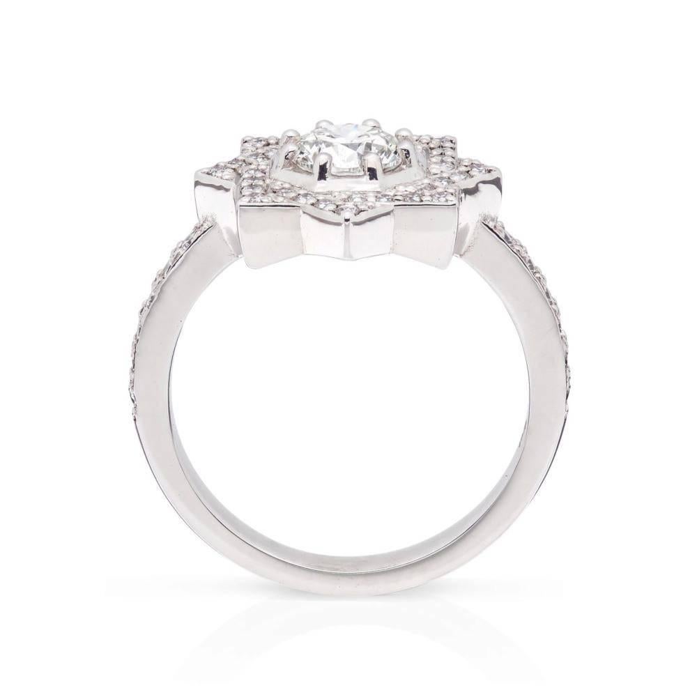 Ring size: 51

Zinnia is by definition a beautiful flower. The layers of soft petals inspired the fluid, folding shapes of this engagement ring.

The central diamond is surrounded by a woven border of pavé set diamonds which flow into the band