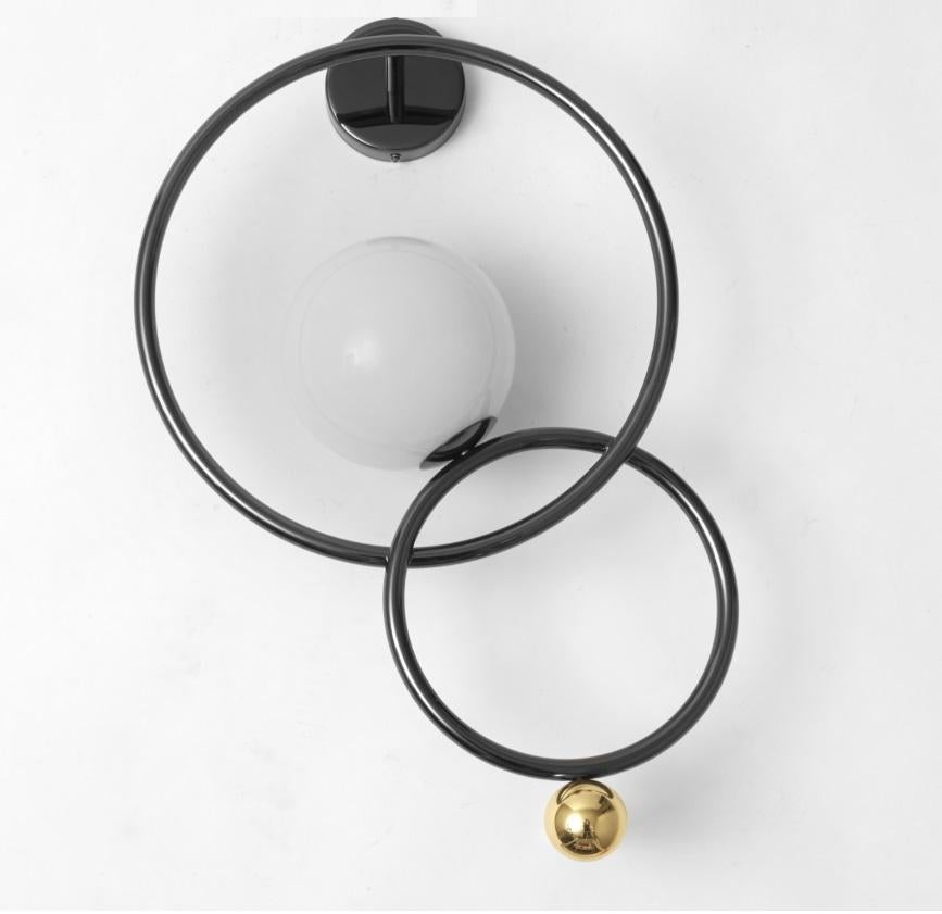 Zoe Applique designed by Melissa Lunardi and Massimo Tonetto for Venicem is a beautiful wall lamp made of two metal rings with a mouth-blown Murano glass diffuser.

This elegant sconce is made of two metal rings with a mouth-blown Murano glass