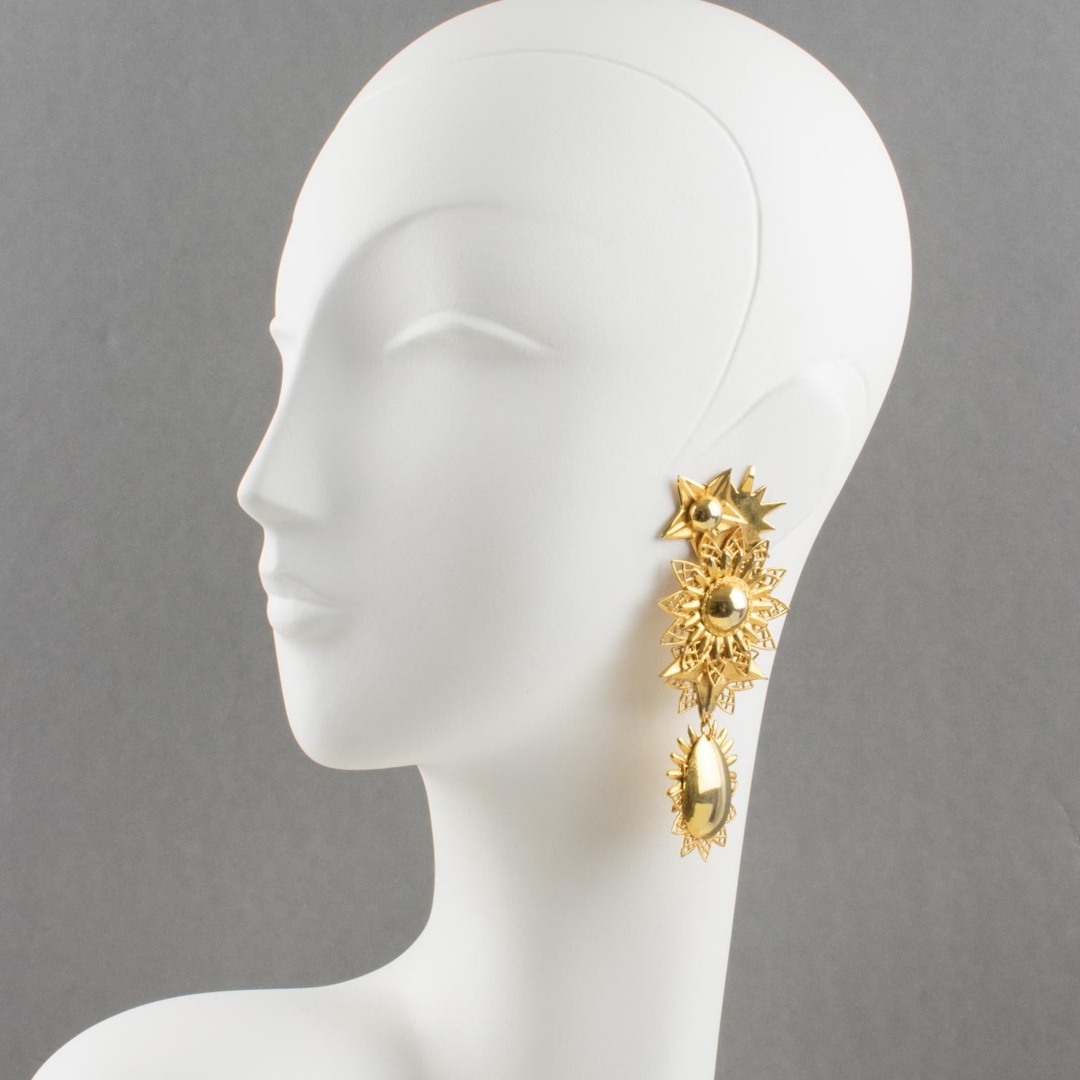 Charming Zoe Coste gilt metal dangling clip-on earrings. Features stars and suns carved design with gilt metal all textured and ornate. Unusual design from that famous French designer, creator of the Reminiscence brand. Marked underside 
