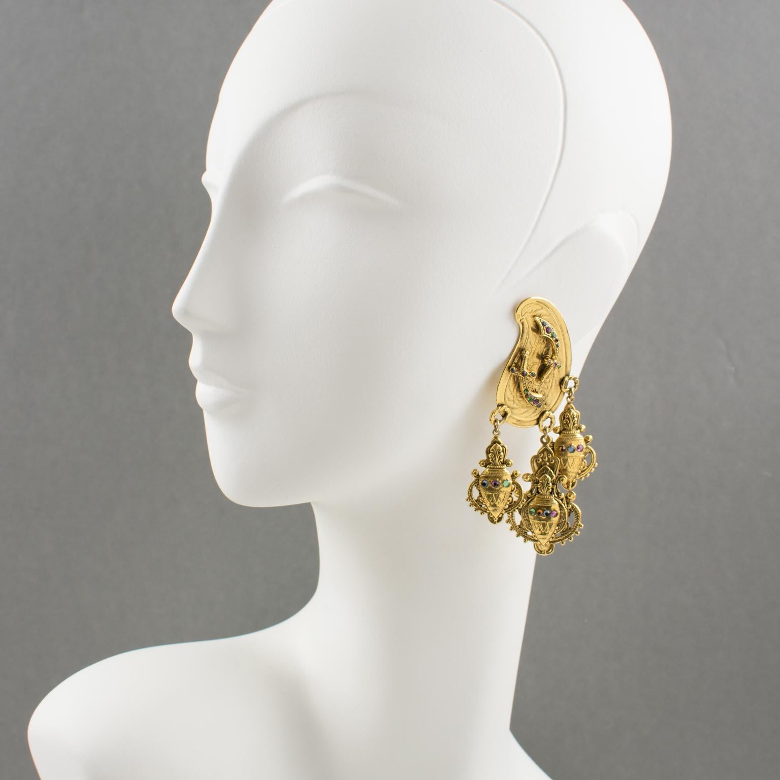 Stunning Zoe Coste gilt metal dangling clip-on earrings. Dramatic flair featuring oriental design with gilt metal all textured ornate with amphora charms and topped with multicolor tiny glass rhinestones. Unusual design from that famous French