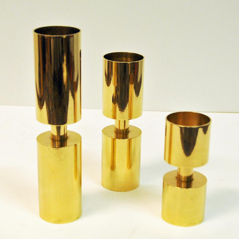 Three brass cylinder-shaped set of tealightholders made for the 90-year anniversary of the Swedish coffee brand Zoégas.
Each candleholder has a Zoéga logo and close to the bottom: Zoégas Kaffe 1886-1976. All have same diameter but are in different