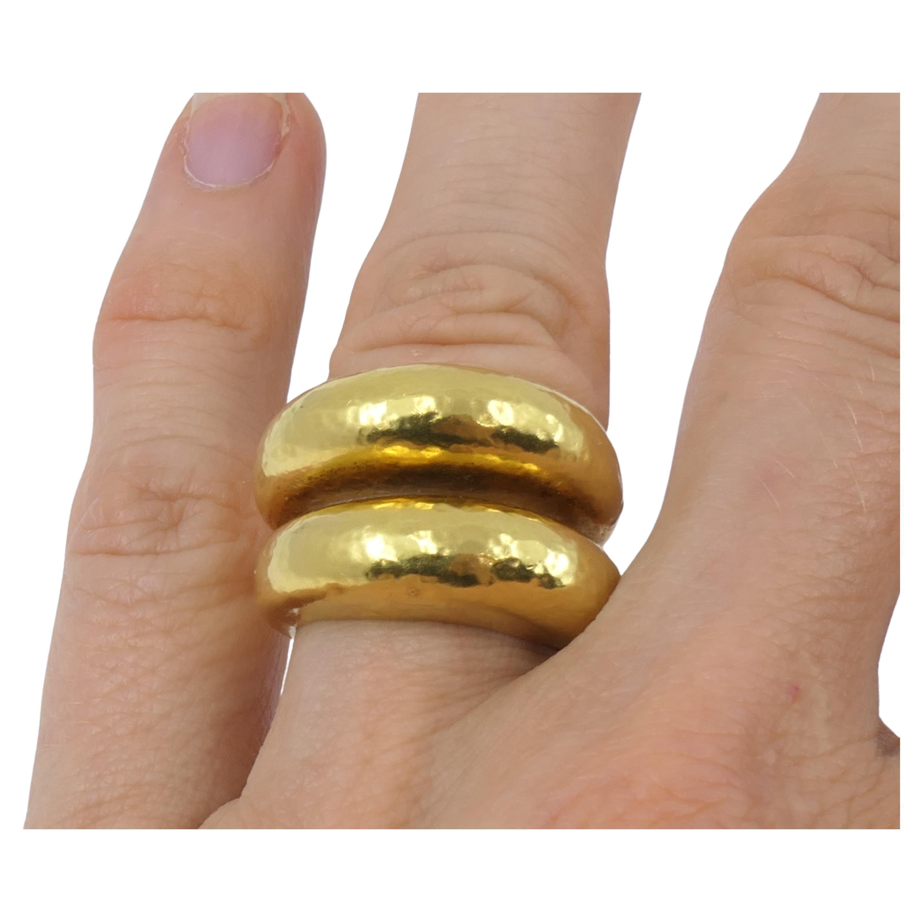 A shiny band ring by Zolotas, made of 22k gold. The ring is crafted as a double band, with an open shank. The gold is slightly hammered to add a unique texture, a signature feature for Zolotas' jewelry. Despite its minimal design, this ring is just