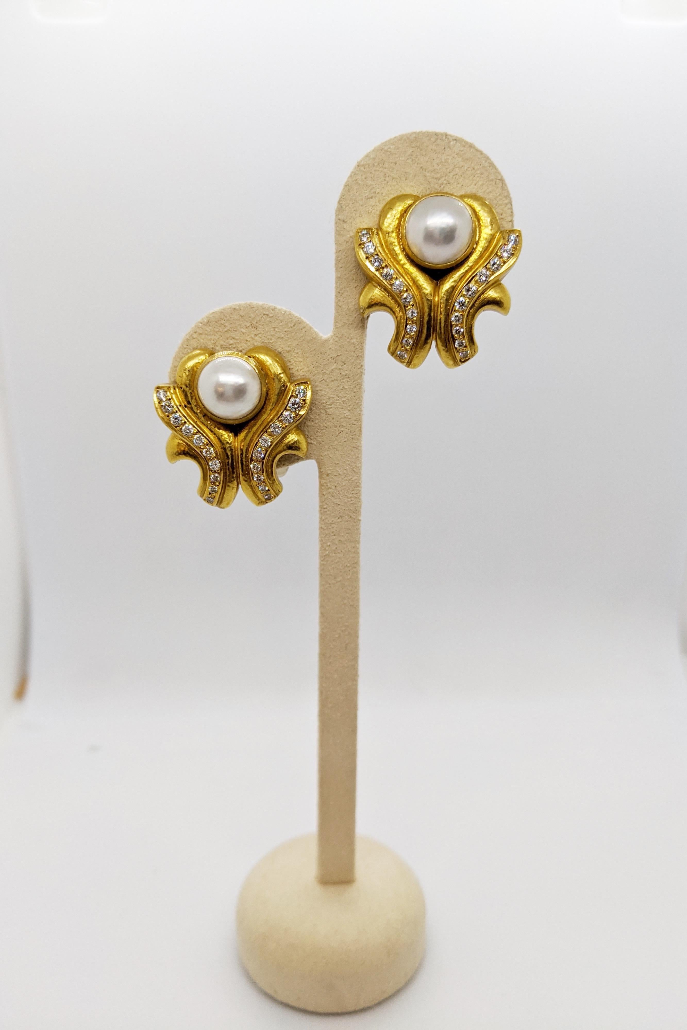 This earrings are designed by Zolotas of Athens , Greece. Founded in 1895 the company merges Greek heritage with modern style to create these timeless pieces. Coveted by Royals and Actresses.
These earrings center a 10.5 mm mabe pearl. Twenty