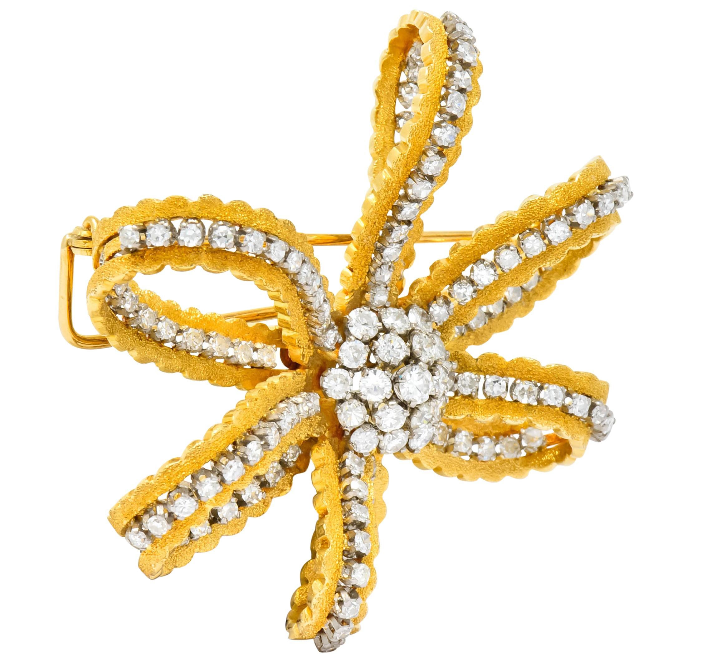 Brooch designed as bow comprised of scalloped ribbon with a stippled matte gold finish

Set throughout with round brilliant cut and single cut diamonds weighing approximately 3.50 carat total, H/I color and VS to SI clarity

Completed by double pin