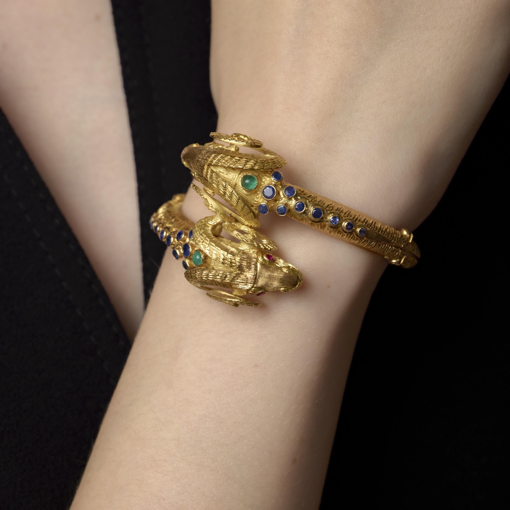 This vintage 18k yellow gold Zolotas bracelet glows with richly colored cabochon sapphires, emeralds, and rubies, masterfully arranged in bold Grecian-inspired design.