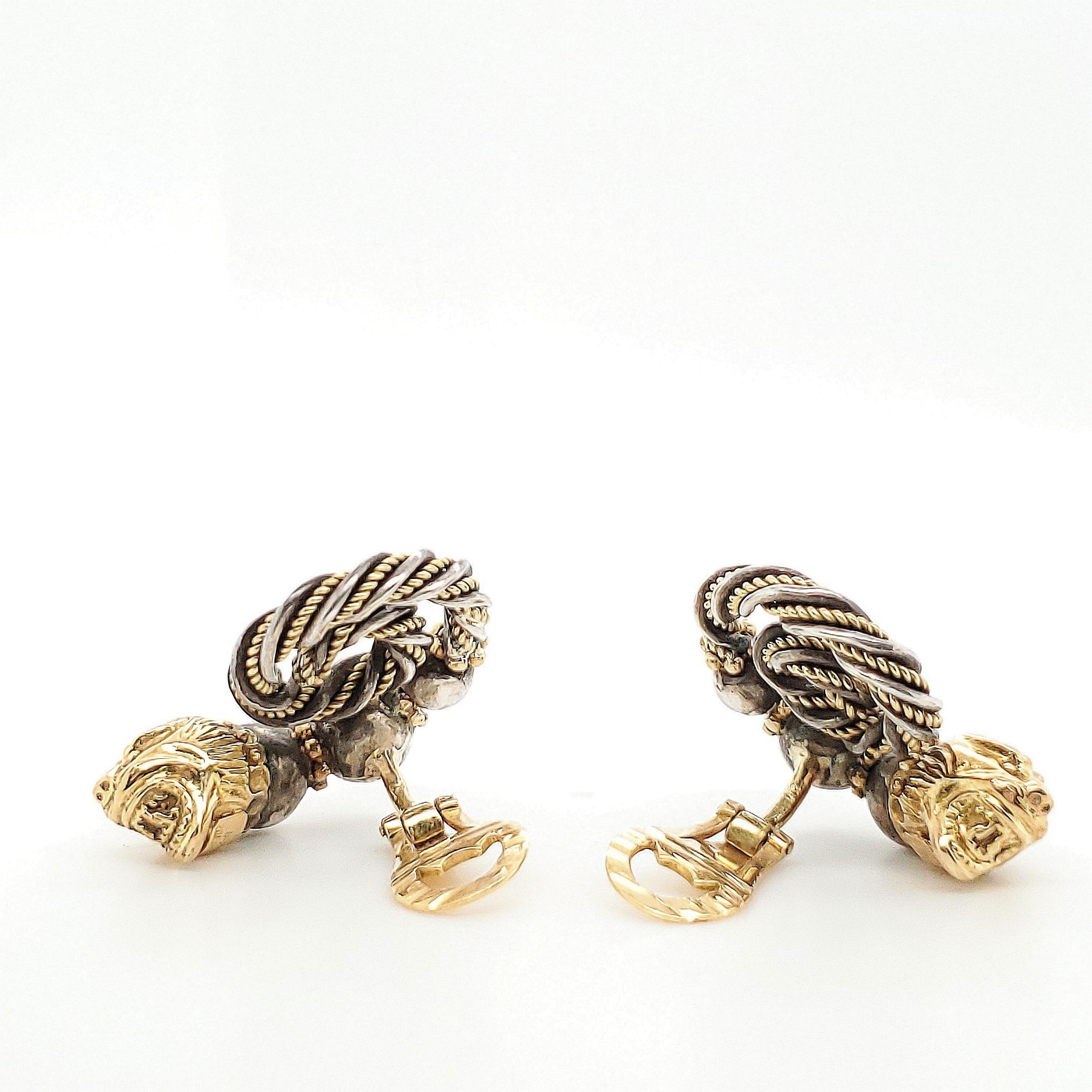 Authentic Zolotas ear clips crafted in 18 karat yellow gold and silver.  The earrings feature a lion head with round silver beads tapering to a spiral of twisted gold and silver.  The ear clips measure 1 1/2 inches in length and 1 inch at the widest