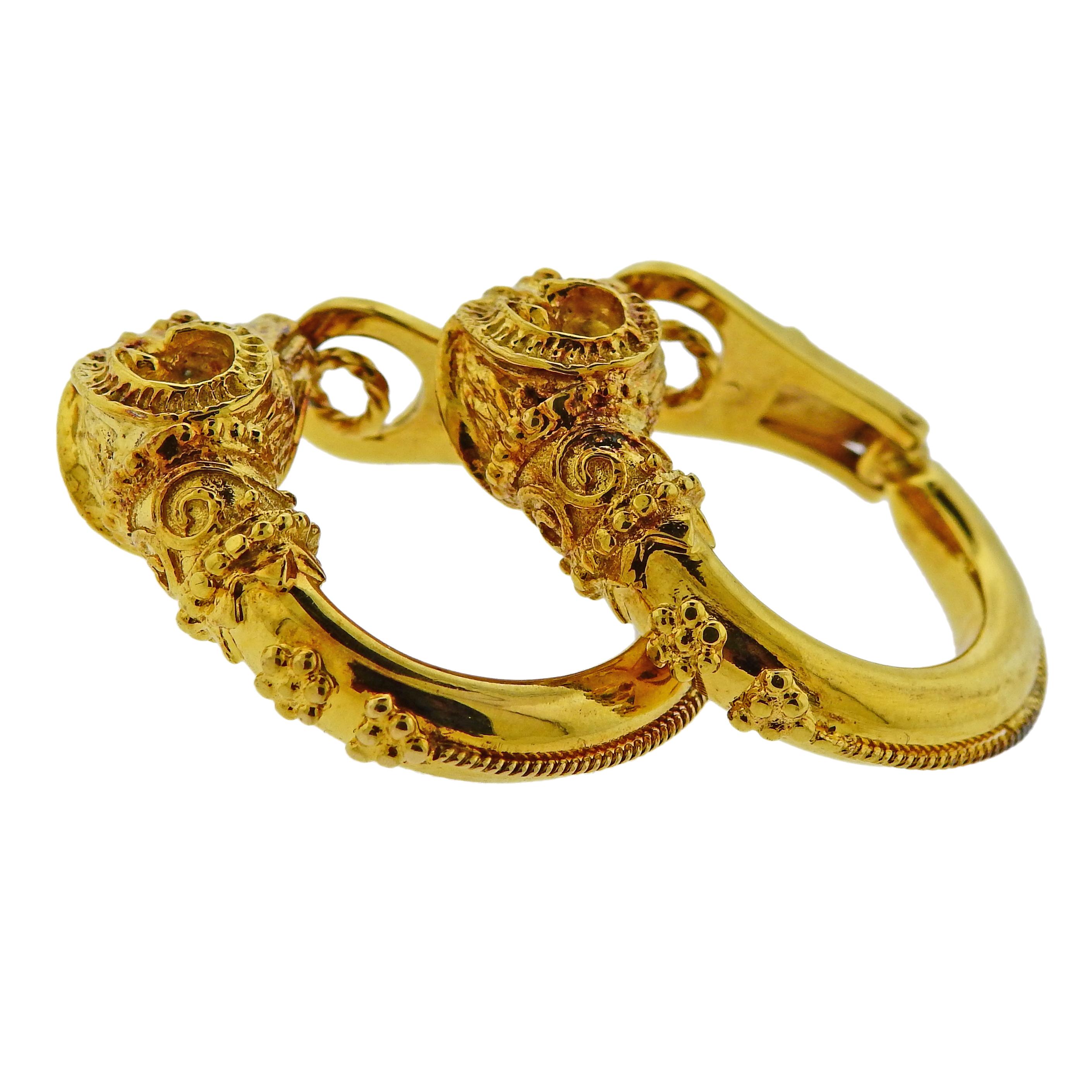 Pair of 18k yellow gold hoop earrings by Zolotas Greece, depicting ram's heads.  Earrings are 28mm in diameter, Ram's head - 11mm x 15mm. Weigh 20.8 grams. Marked: Zolotas, 750. 