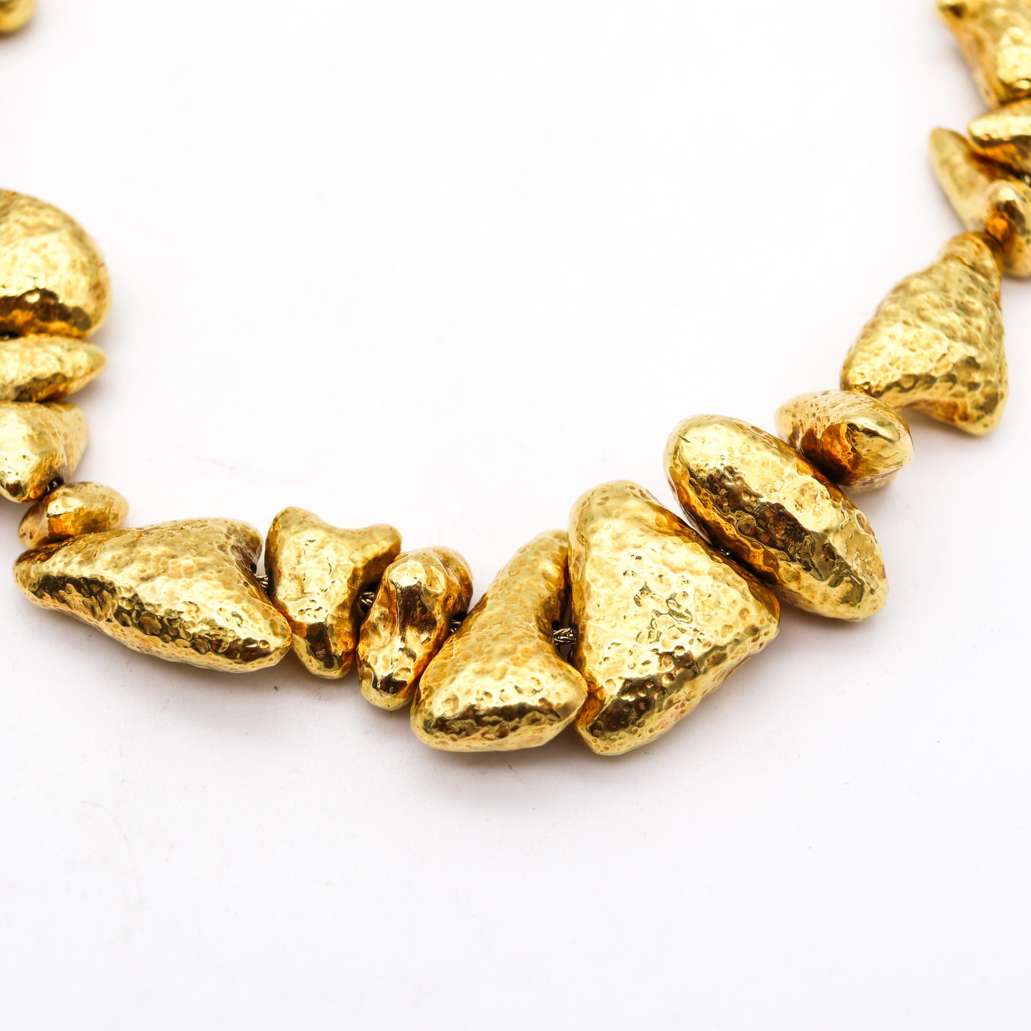 Necklace designed by Zolotas.

Gorgeous necklace, created in Greece by the jewelry house of Zolotas back in the late 20th century. This necklace has been crafted with multiples elements in the shape of gold stone nuggets in solid yellow gold of 18