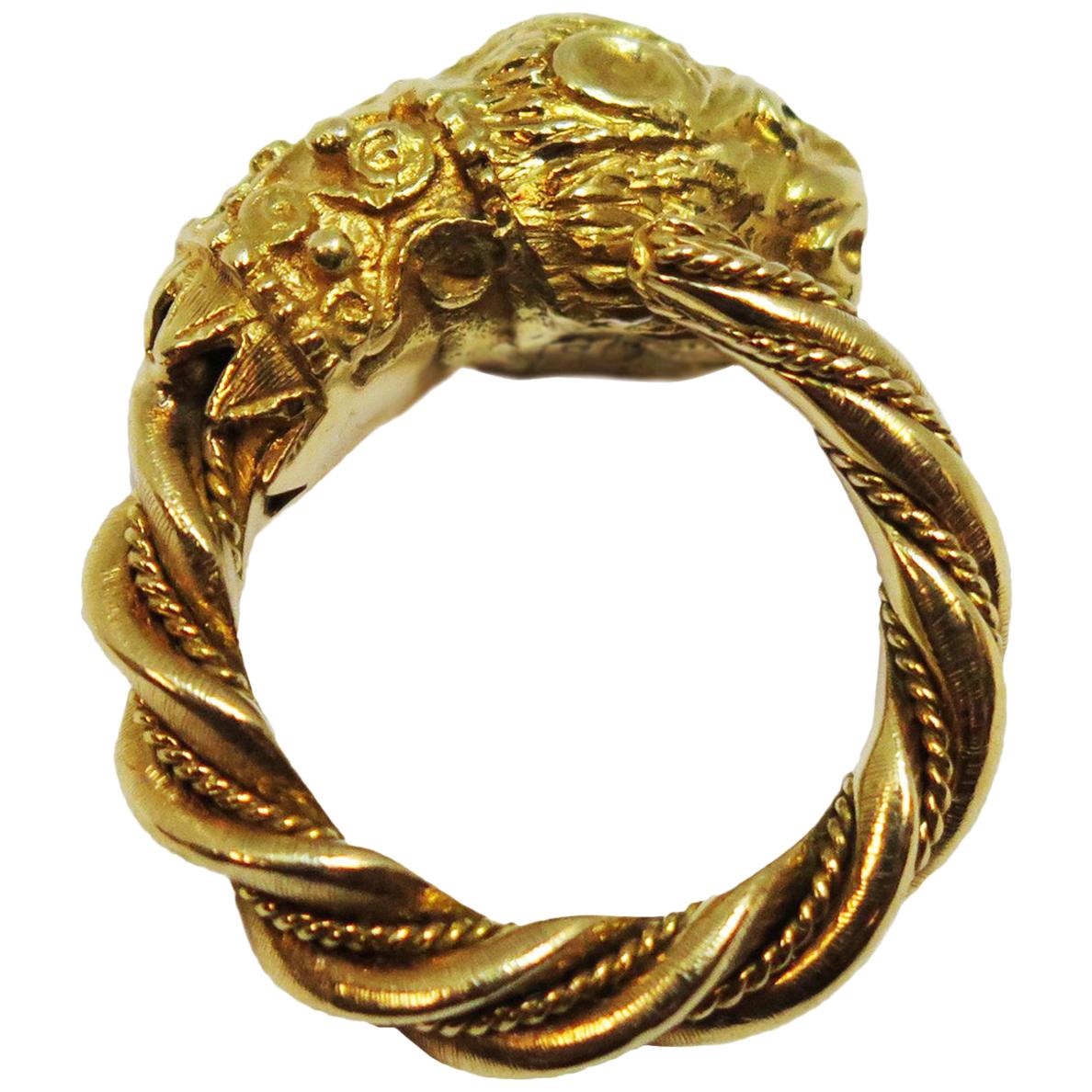 Circa 1980s Zolotas Greece Chimera Head 18k Yellow Gold Ring, hand made with traditional Ancient geek Roman design, 4.5 MM thick shank with the top measuring 7/8 inch across. Set with Ruby Eyes. 