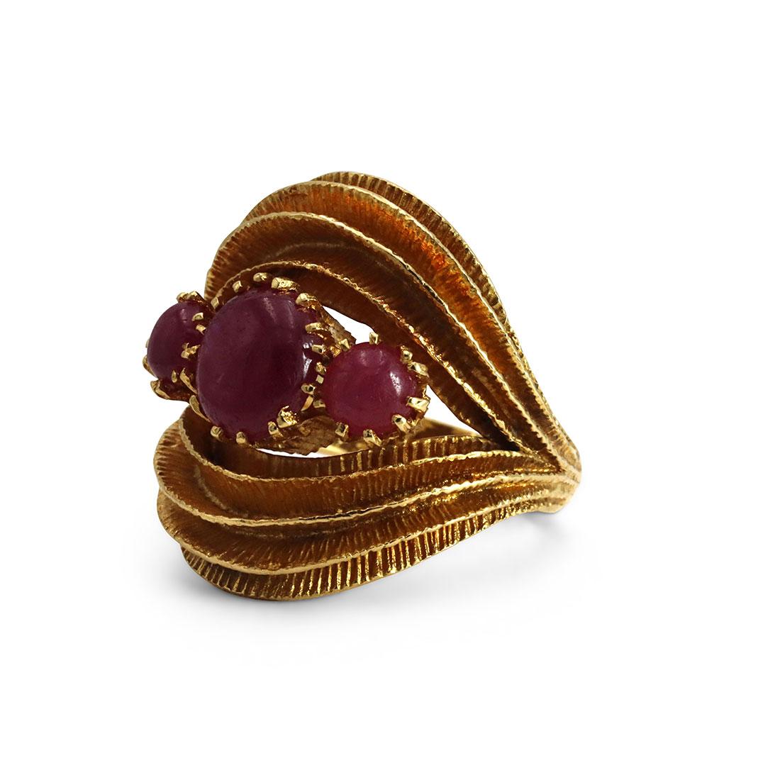 Authentic vintage Zolotas ring, crafted in 18 karat Yellow Gold and set with three ruby cabochons. Fine Textured gold flaps encircle the rubies, giving the impression of a delicate jewel box.  US size 6 1/2.  Stamped 750, A51, with Zolotas maker's