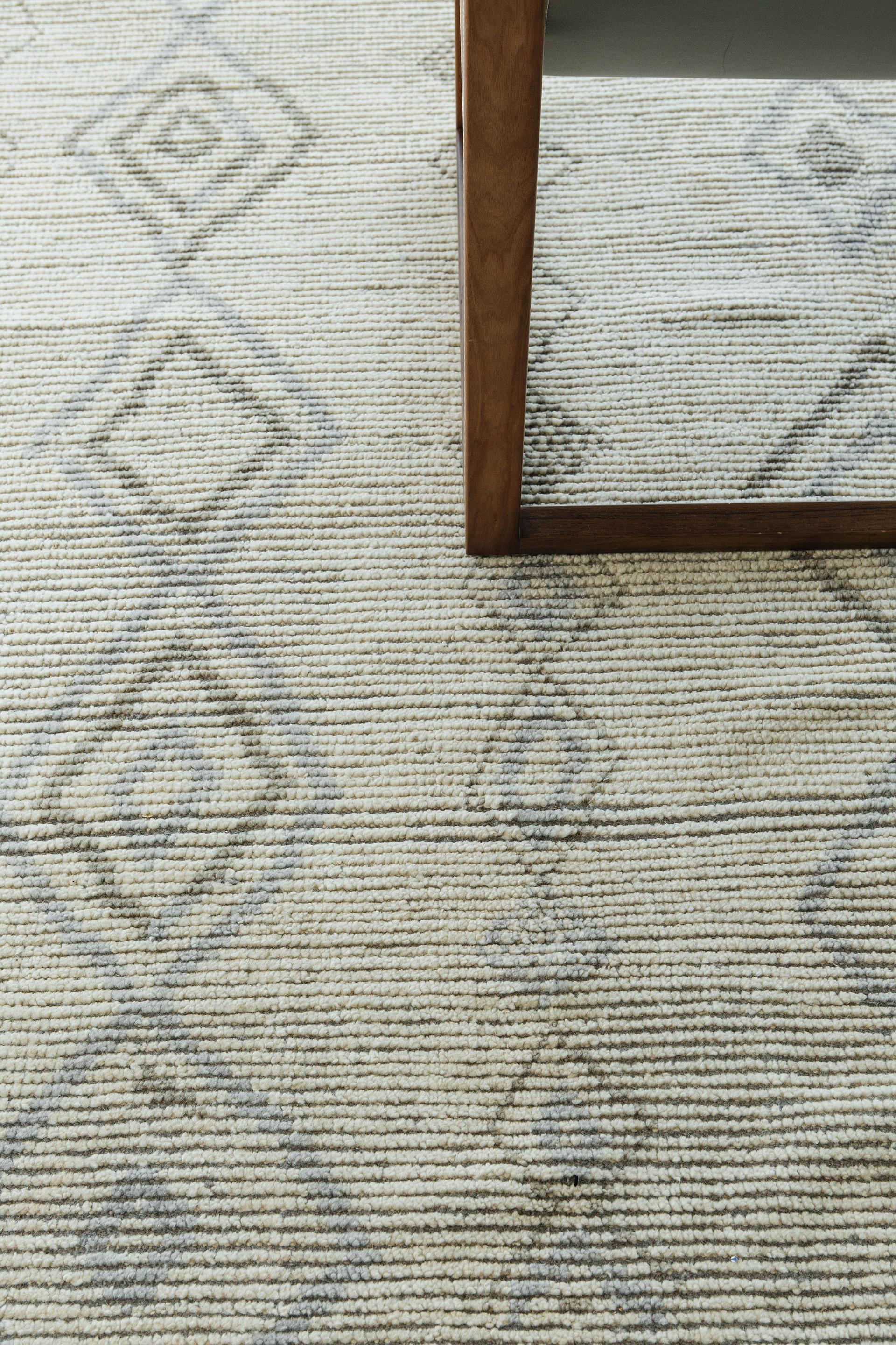 Designed in Los Angeles with inspiration from the Atlas Mountains of Morocco is this unique tribal rug. Weaved with handspun wool, this pile weave consists of a charming ribbed surface as well as intuitive diamond motifs that are latticed in