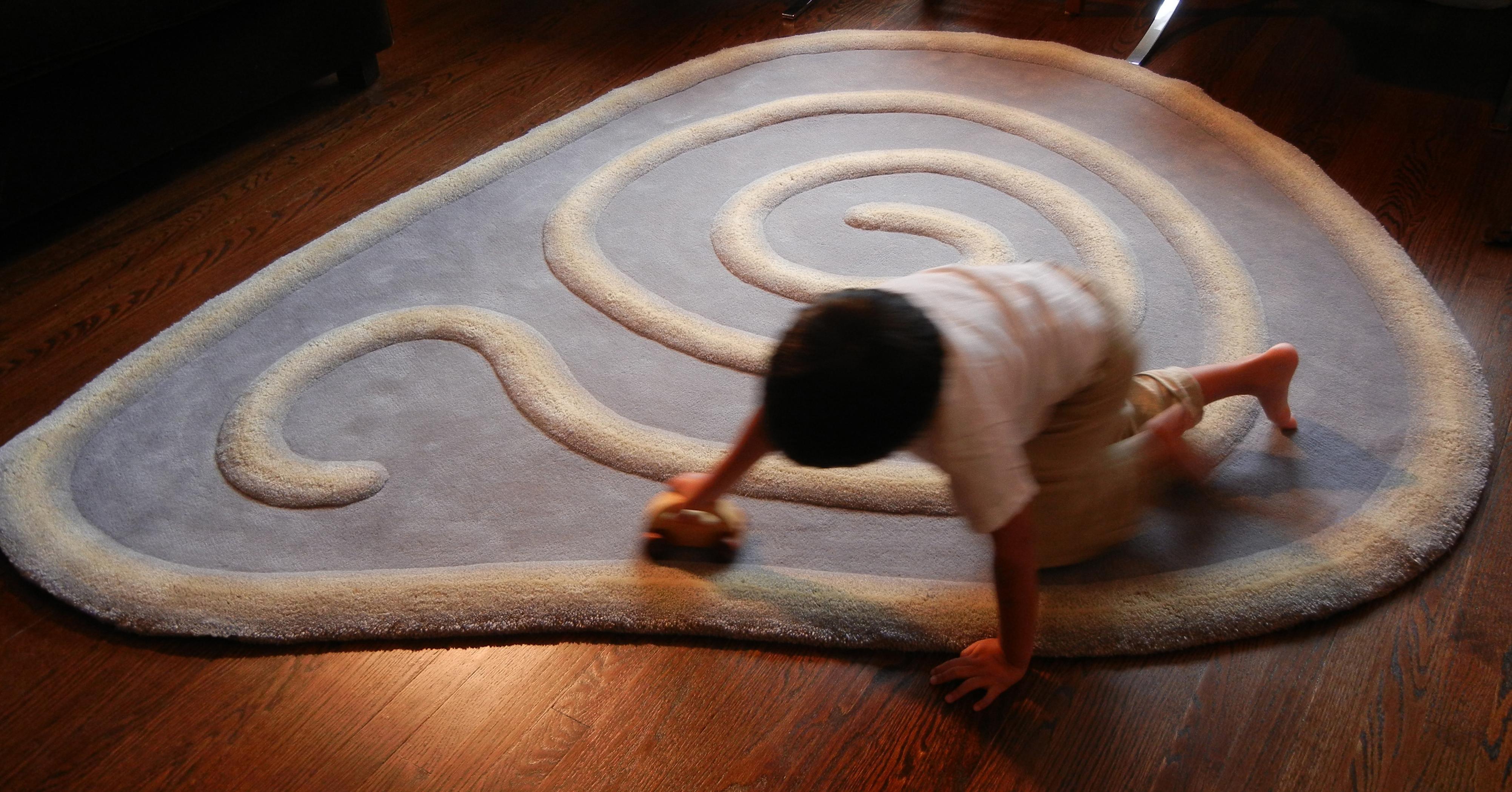 Handtufted wool. 'Zoom' children's rug by Jody Harrow for Groundplans. Race cars on a carpet track to promote hand-eye coordination while having fun. 

Available as a 5' x 4'6