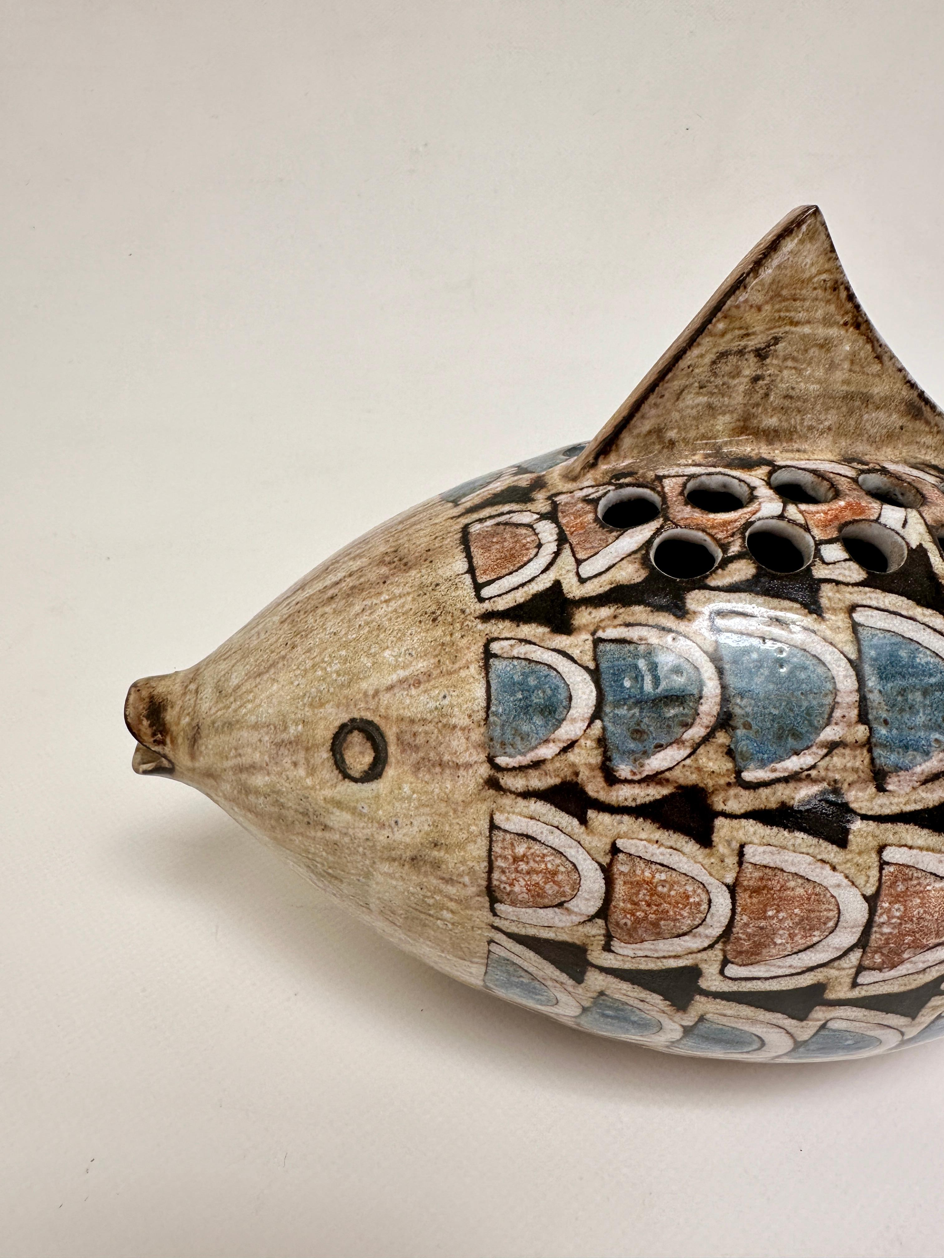 Garden vase in the shape of a fish in red earth from Vallauris, glazes in muted tones and patterns evoking oriental decorative ceramics.

Graduated of the Ecole des Beaux Arts in Reims, Jean-Claude Malarmey joined his classmate Robert Perot in 1954