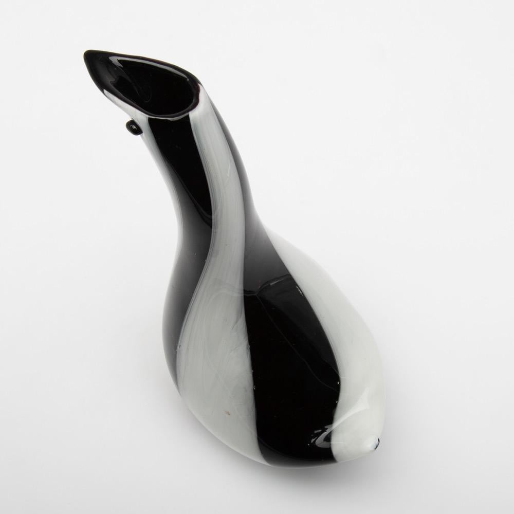 Italian Zoomorphic glass vase that we believe to have been designed by Dino Martens for Aureliano Toso Murano
The vase is shaped as an elegant and stylized bird with very tiny eyes.
Body of the piece is made of blown Murano black base with deep