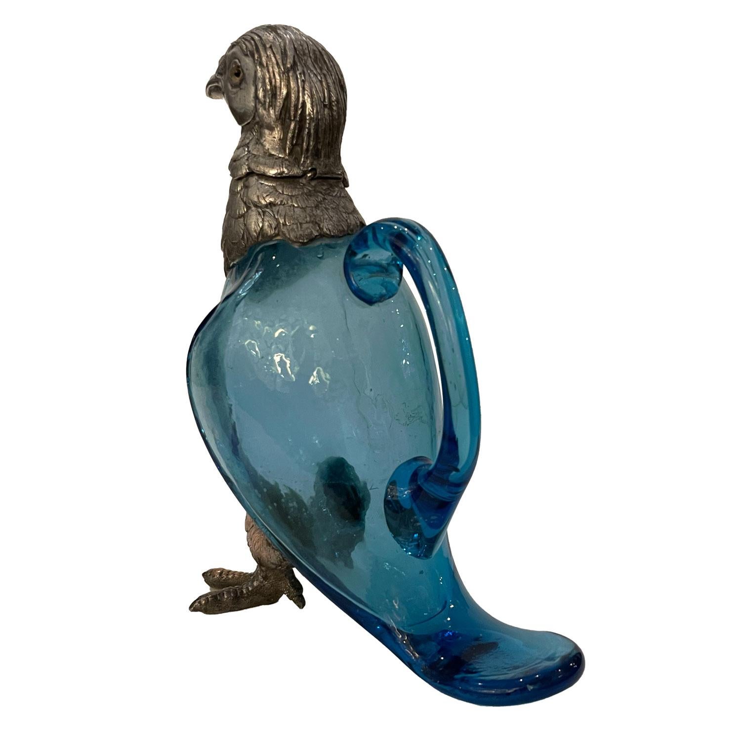 Original zoomorphic pitcher ewer in the shape of a partridge. Beautiful item made of silver plate for the head of the partridge nicely chiseled showing the lovely texture of feathers and blown blue glass for the body part, with a handle on the back.