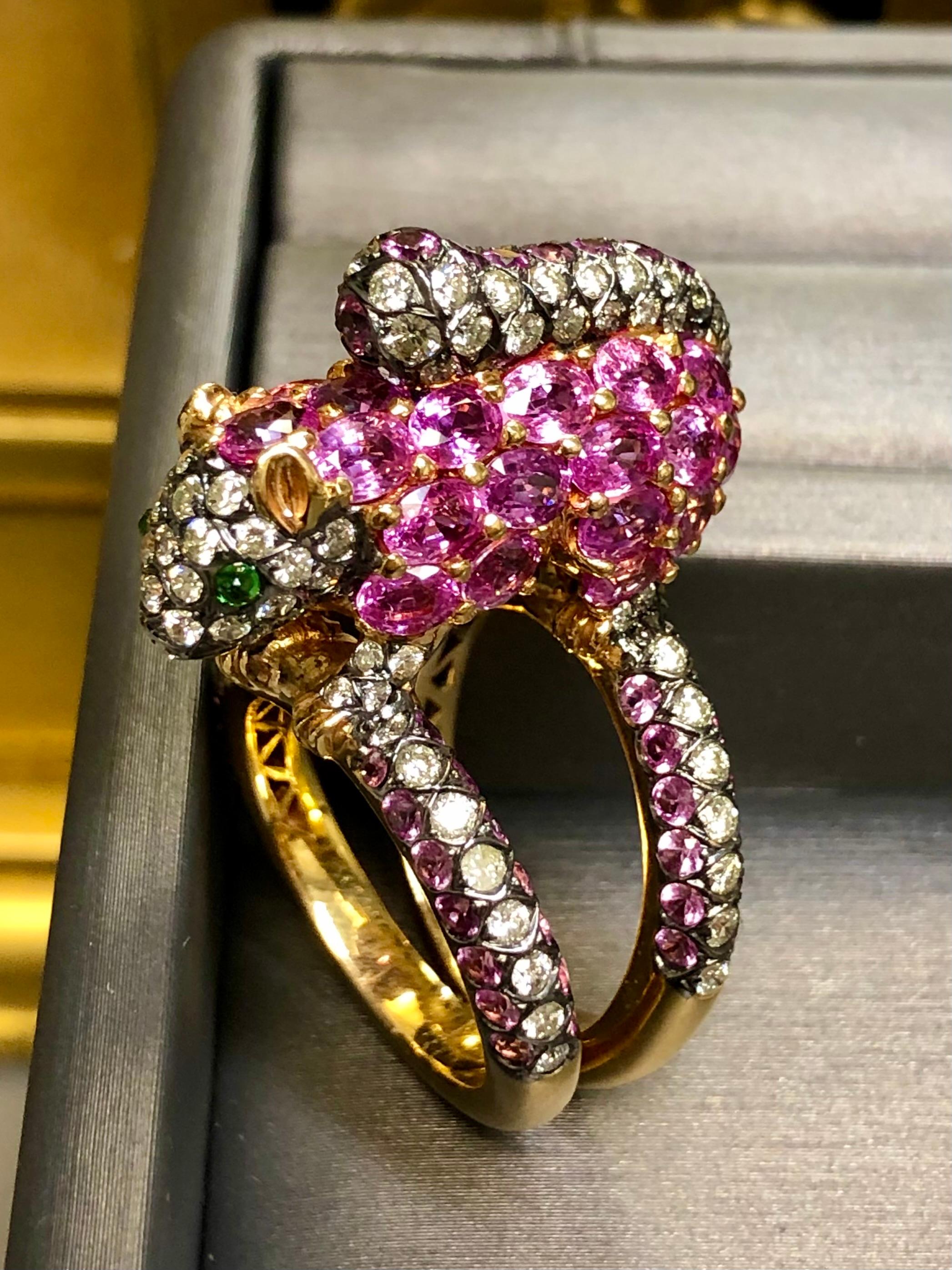A whimsical cocktail ring by designer “ZORAB”. It has been done in 18K yellow gold and set with approximately 2.12cttw in J-K Si1-2 diamonds as well as approximately 6.90cttw in natural, vibrant pink sapphires. This little furry woodland creature