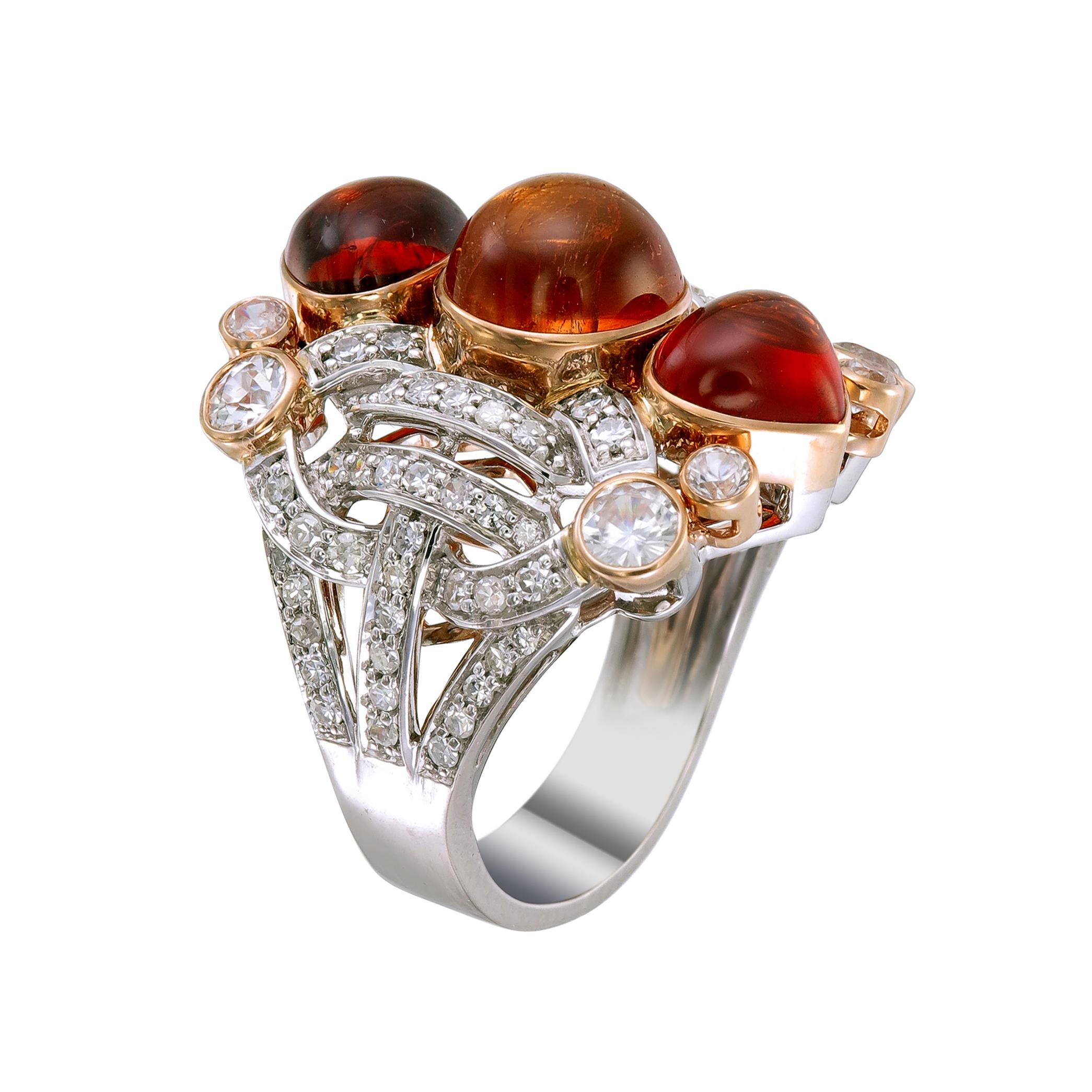 Three round cabochon spessartite garnets totaling more than 10.13-carats in varying shades of orange shine brightly on this 18k white gold and palladium ring paved with 0.80-carat diamonds and 1.50-carat of white sapphires. 

This ring, as with all