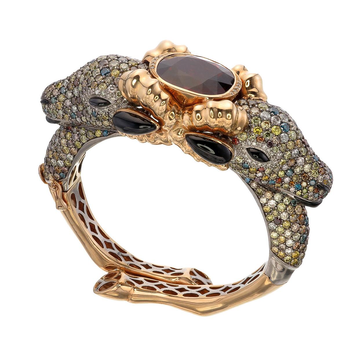 Sauvage Collection- One of a Kind Bangle

A two-faced Ram bangle holds the fiery 36.15-carat Spessartite Garnet in the middle displays the symphony of this exquisite masterwork. With 25.68-carat of fancy diamonds, it harmonizes an irresistible aura