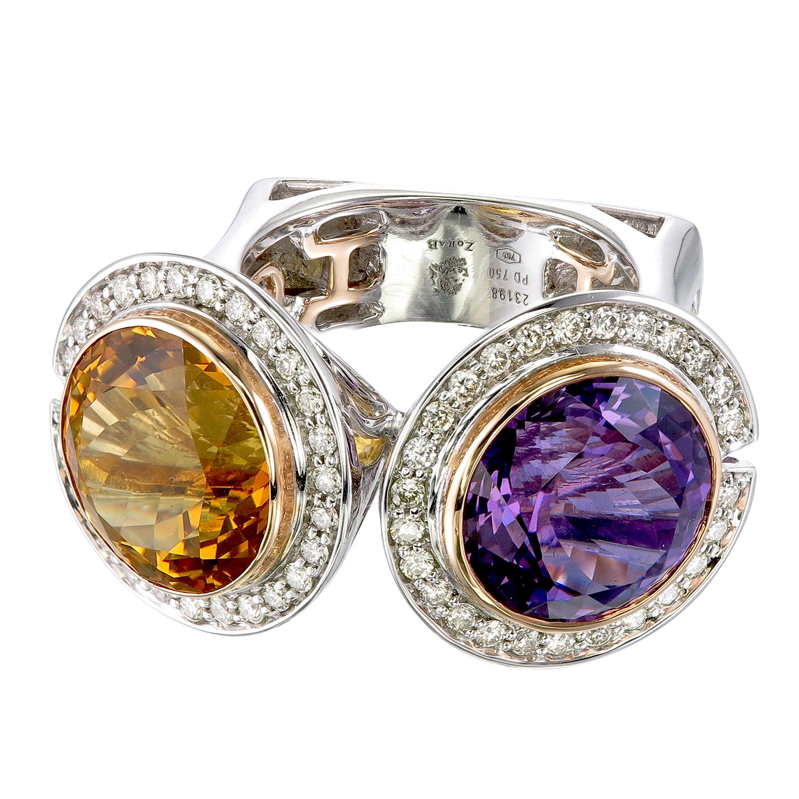 Citrine and amethyst never looked so good together as they do on this 18k gold and palladium ring. Both round cuts, the citrine weighs 7.52-carats while the amethyst weighs 8.43-carats. Together, the colors and shape complement one another