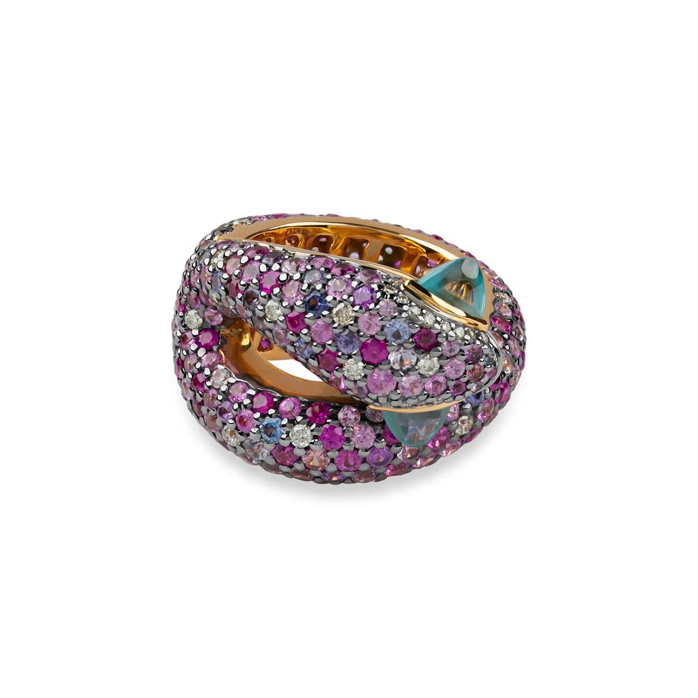 
Distinctive and bold, this very unique snake inspired ring hypnotizes with speckles of pale blue and pink gems to create that ornate reptilian hue. 
This ‘C’-shaped ring is crafted from 1.07 carat blue zircon and 7.29 carat pink sapphire, with