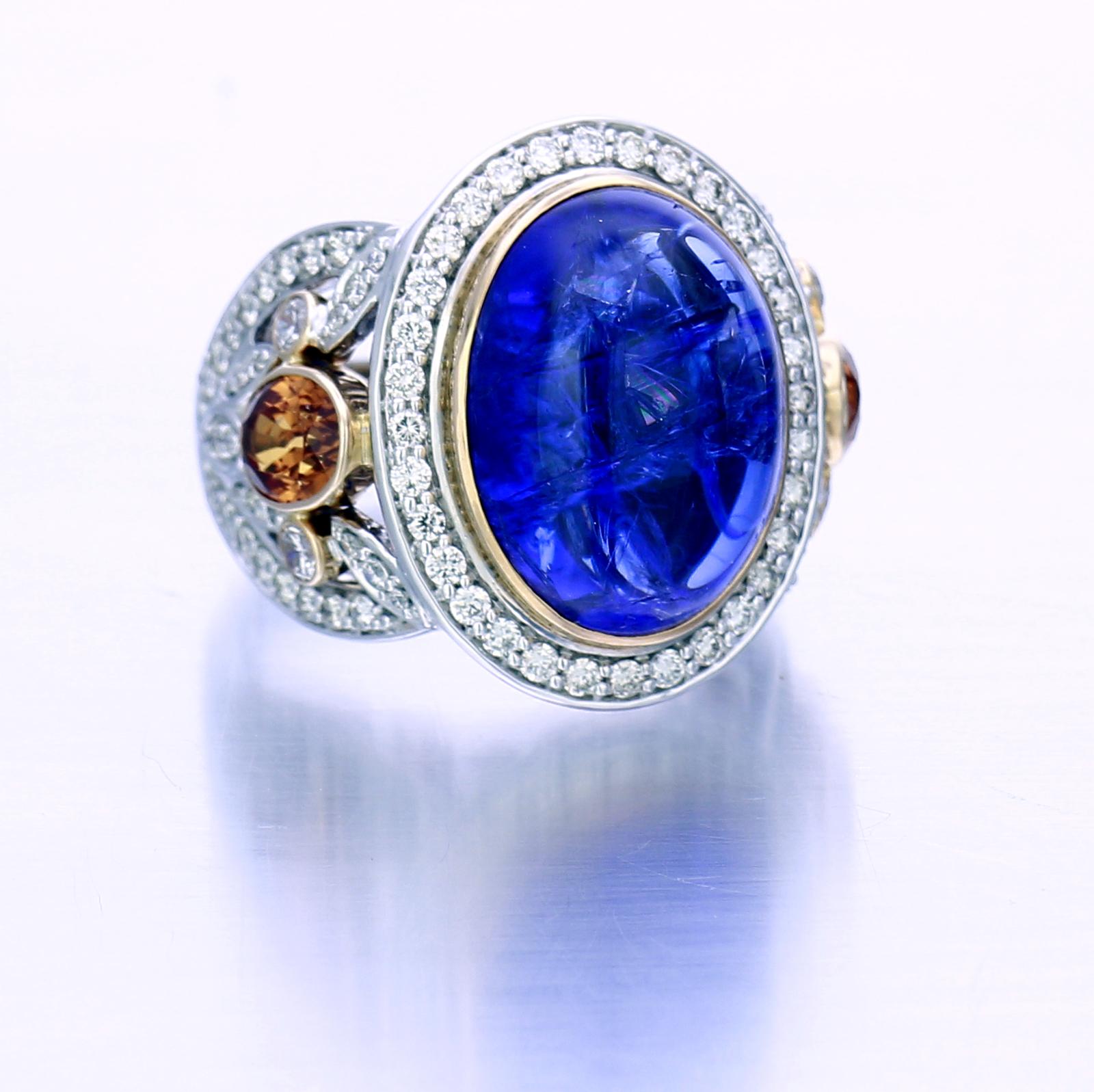 A 15-carat bright blue Tanzanite surrounded by 1.08-carat of Diamond pavé may be the main attraction of this ring but not the only notable quality. The decorative elements on the sides of the jewels reveal superb craftsmanship in 18K and Palladium