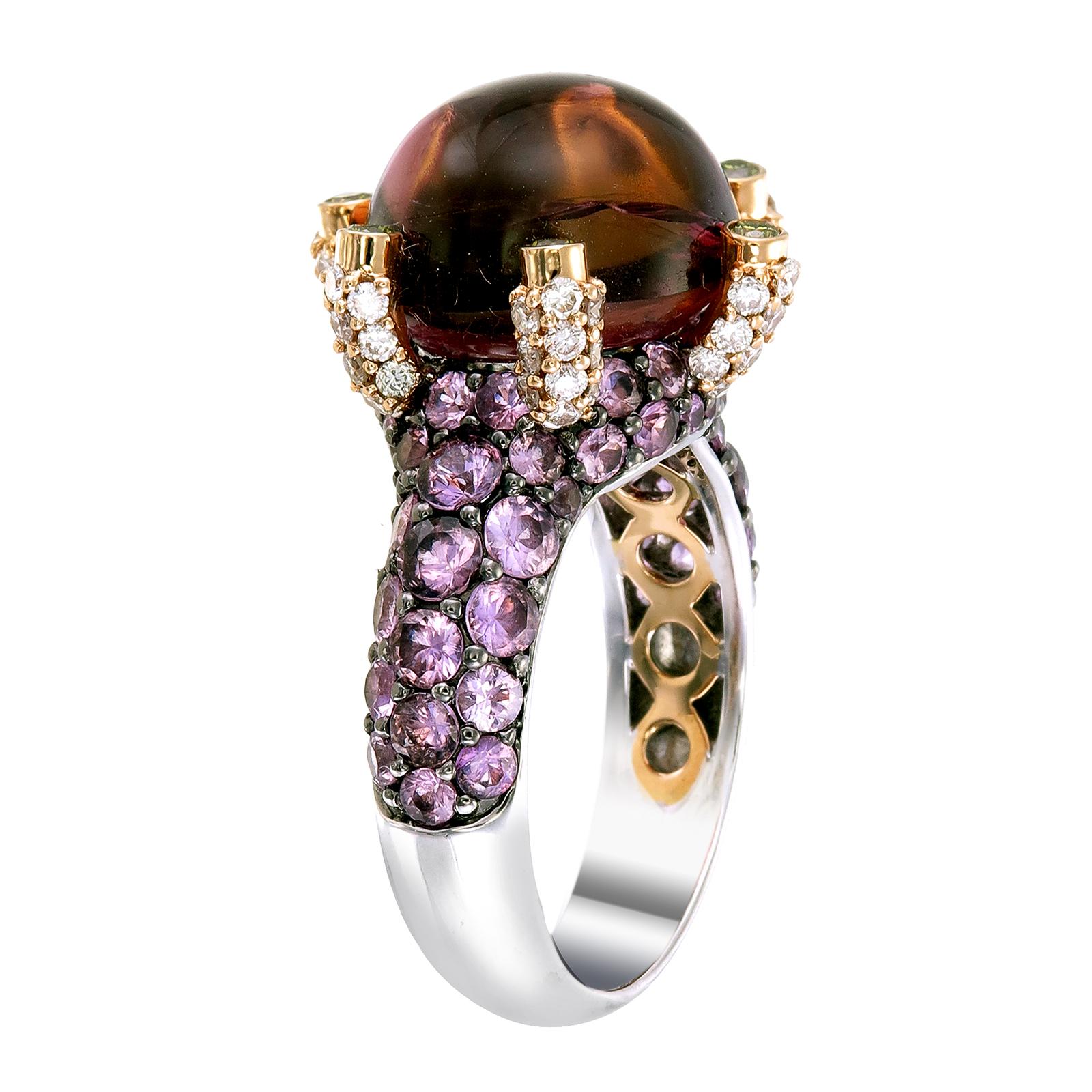 A 10.40-carat round Pink Tourmaline sits high like a colorful crystal ball on a 18k gold and palladium ring protected by 0.14-carat Yellow Diamonds. The ring’s surface is paved with 2.70-carat of Pink Sapphire and 0.59-carat of White Diamonds.