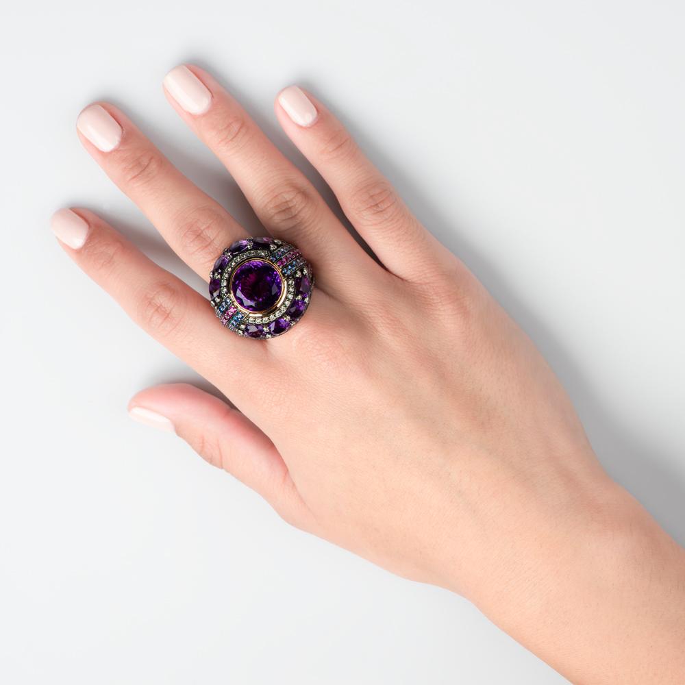 Opulence equals art deco and the opulent color of the era: majestic purple. 1920's flappers fled platinum's weight and white gold was introduced to the world.  Bold lines interfaced with circular motifs and the super-rich sought symmetry. Welcome to