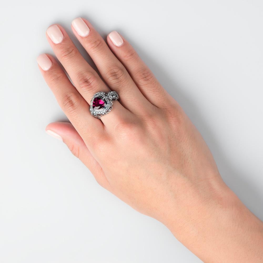 Thoroughly elegant and ornate, this rubellite and white diamond ring will truly capture your heart.

With a 2.40 karat heart-shaped rubellite tourmaline as the central focus, it is housed within a 0.40 carat white diamond encrusted nest. 
The