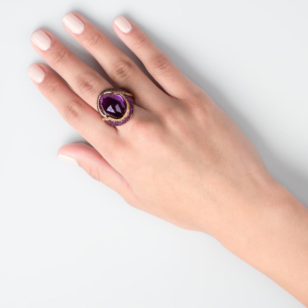 
Dubbed the lion-heart ring due to its brave and inimitable style, this bold and beautiful piece centers around the main 20.63 carats undulating Amethyst Quartz gem. This amethyst is edged with a yellow gold and 0.63 carats of White Diamond trim
