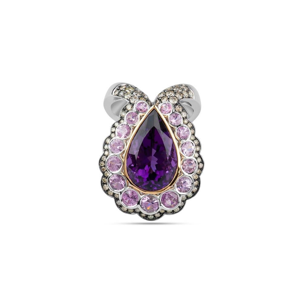 This piece really does offer its wearer a generous magnificence of style and quality stones. The stunning centerpiece is crafted from a 10.58 carat Amethyst Quartz and sat within a 3.22 carat array of dainty Pink Sapphires, 0.83 carats of White