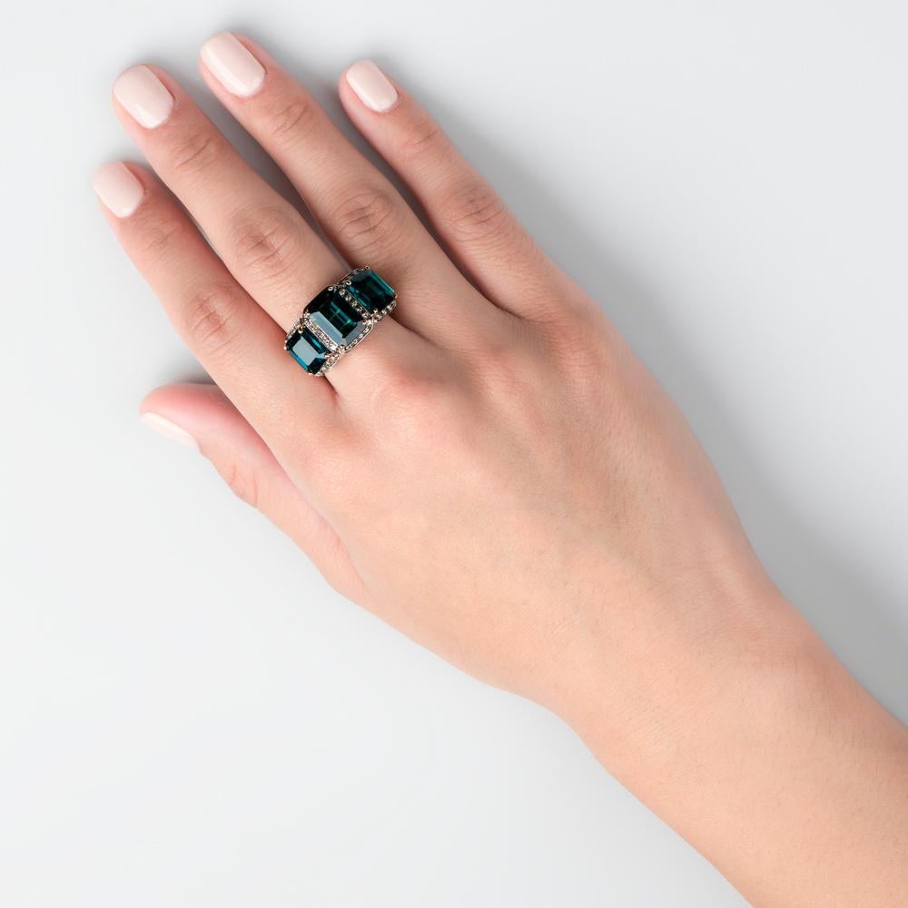The clandestine and enigmatic color of the Tourmaline gem really shines through here within this Trifecta Ring. 

So-called as its wearer has the honor of toting three immaculately sculpted geometric facets of  Aqua Green Tourmaline totaling 7.65
