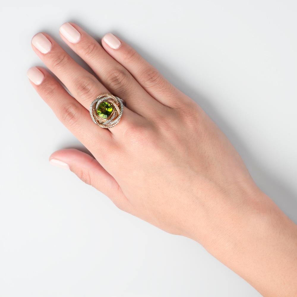 Not all exquisite roses are red, and this mesmerizing and enigmatic peridot ring casts an envy inducing green hue. The central bud element of this rose inspired design features a 4.06 carats of a beautiful Peridot gem, this is nestled within a