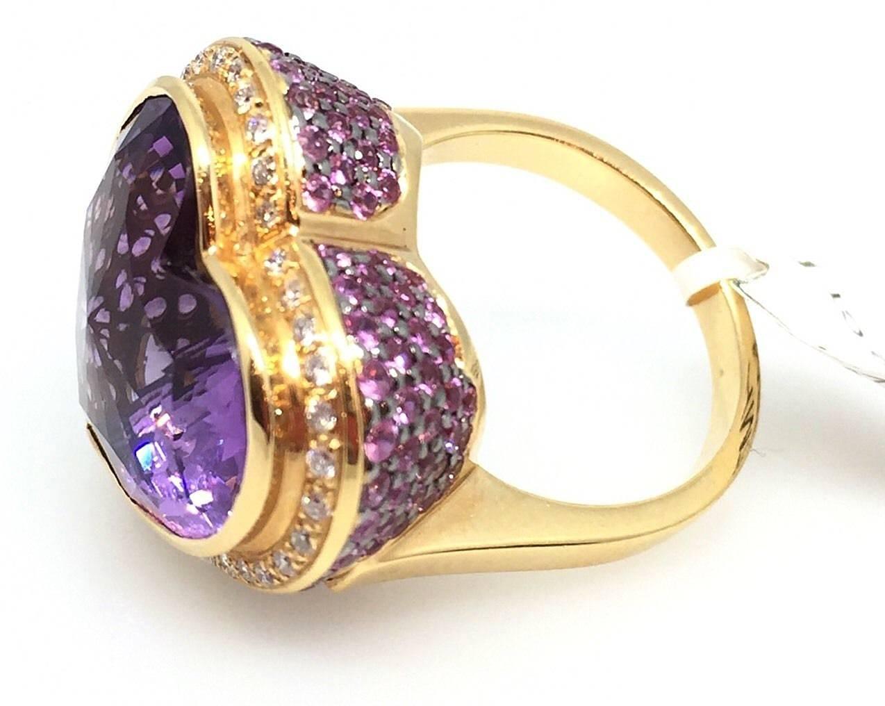 Heart shaped Amethyst and Multi-gem Ring by Zorab featuring a  Fancy Heart Shaped 
Brilliant Amethyst measuring 17mm x 16mm and weighing 13.56 carats, Bezel set in the center. High setting surrounded by Round Brilliant diamonds totaling 0.36